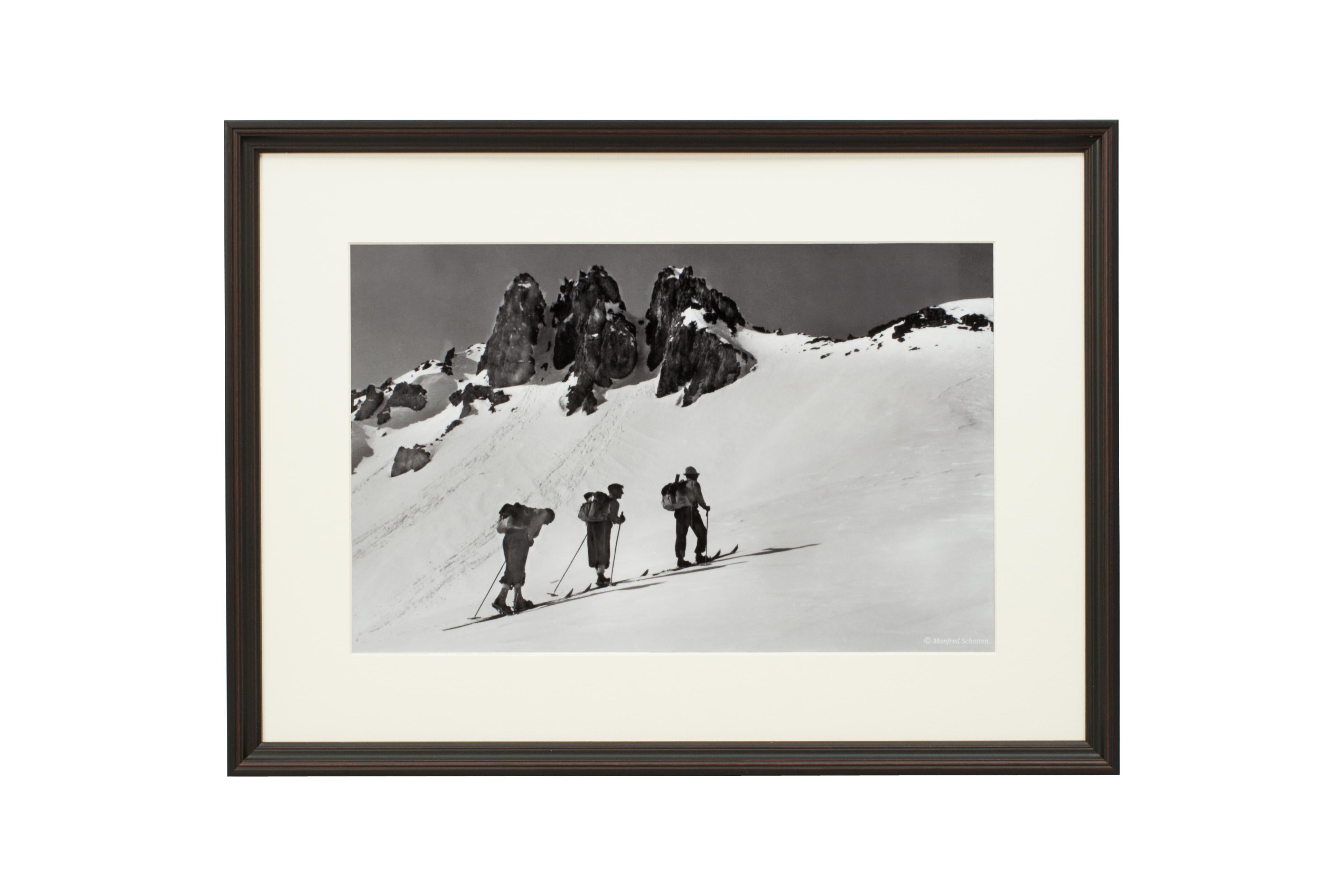 'THREE PEAKS', a modern framed and mounted black and white photograph after an original 1930's skiing photograph. The frame is black with a burgundy undercoat, the glazing is clarity+ premium synthetic glass. Black & white alpine photos are the