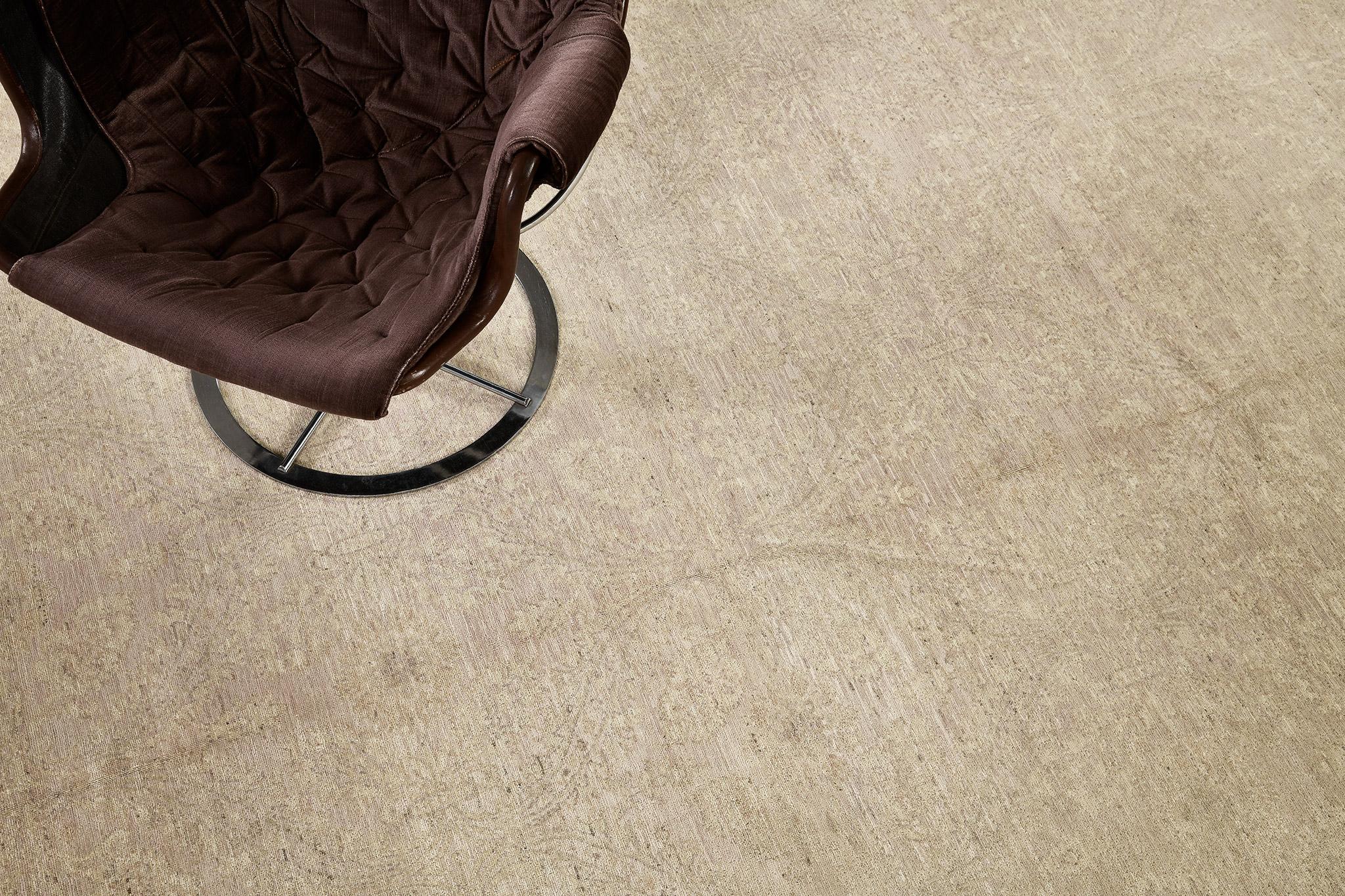 A sophisticated rug that embodies a magnificent transitional style featuring the warm tones of tan and sand. The abrashed tan field with all-over blooming palmettes and serrated leaves exudes timeless elegance. A stylish piece of art that will