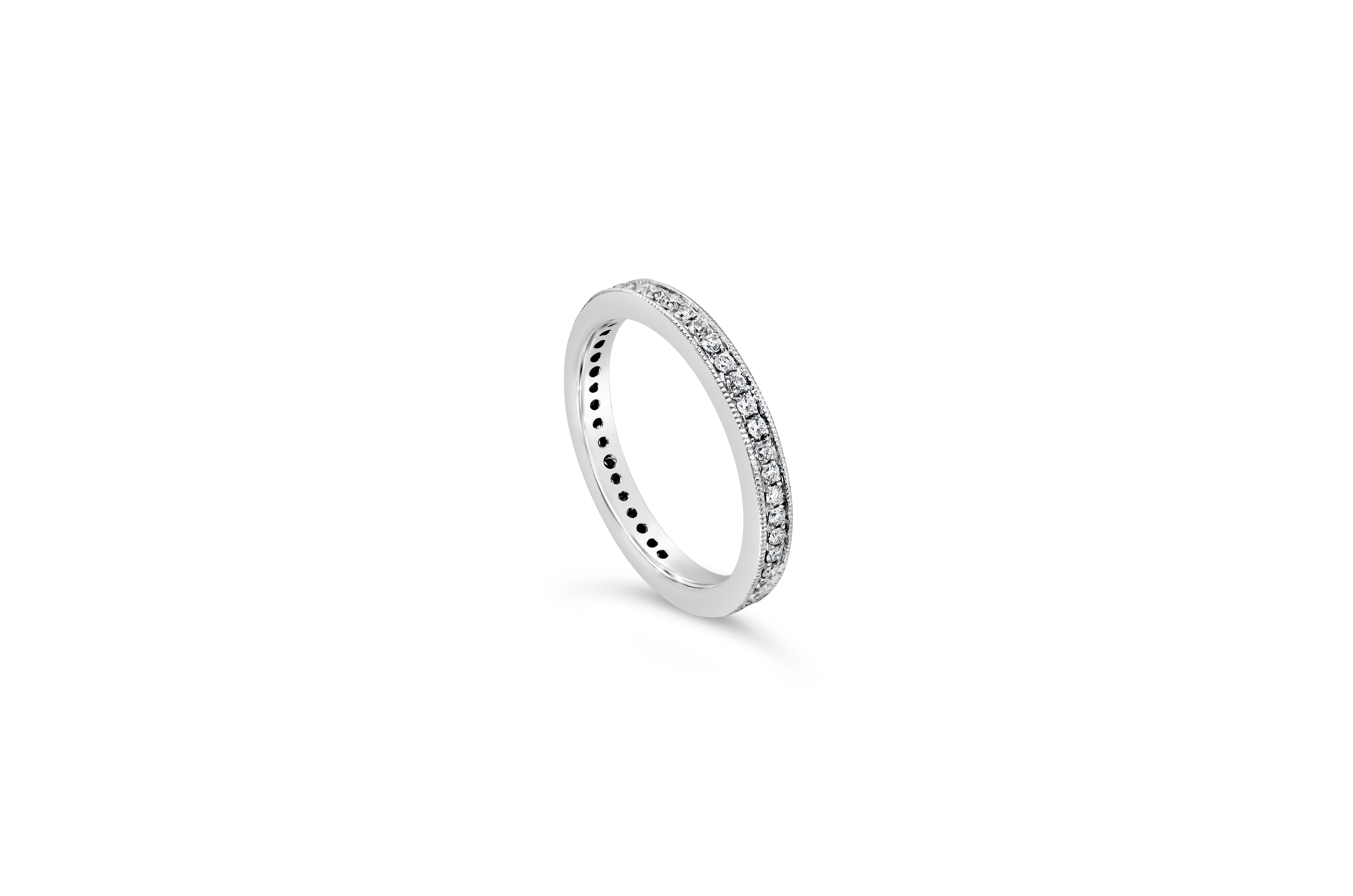 A classic and timeless eternity wedding band style features brilliant round diamonds weighing 0.36 carats.Channel-set and finished with intricate milgrain edges and a hand-engraved design. Finely made in 18K White Gold, Size 6.5 US resizable upon