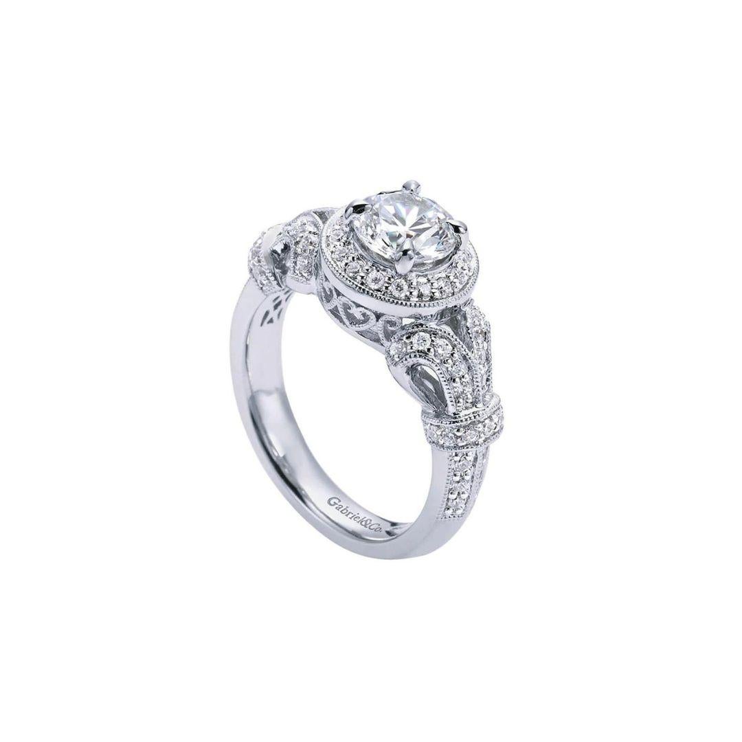 Vintage Style Round Diamond Halo Engagement Mounting in White Gold. Exquisite filigree and pave design blend gracefully in an elaborate antique inspired design. Center diamond NOT included. Total carat weight of side diamonds is 0.40 ctw, H color,