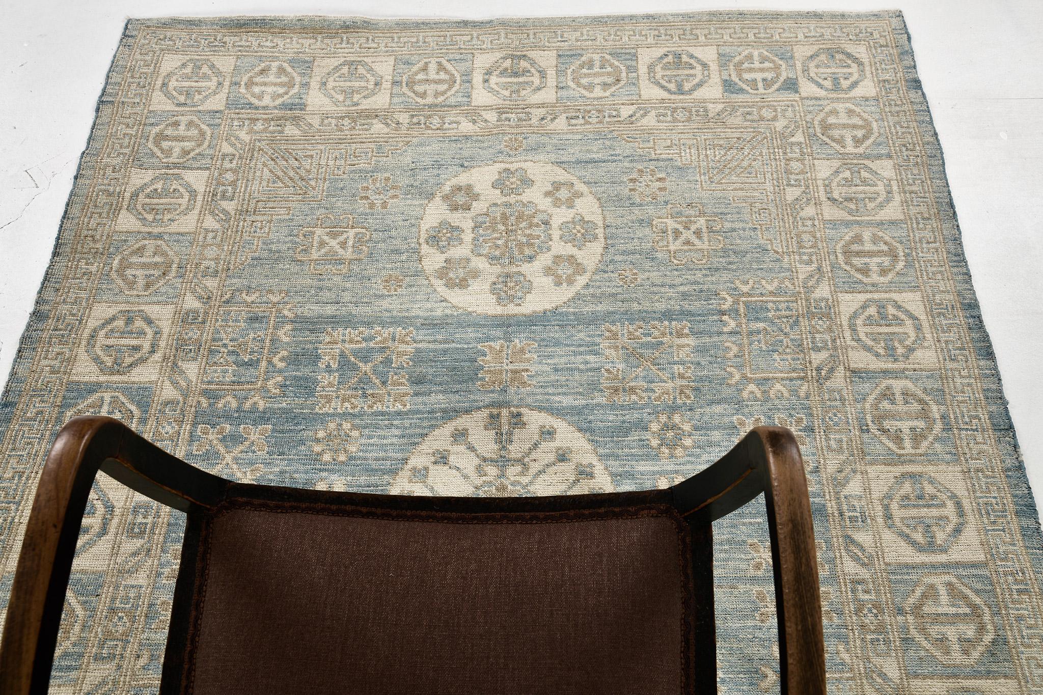 A majestic revival Khotan rug that establishes a unique character by the intricately incorporated elements and unique colour combinations. The tranquil effect by the abrashed cobalt field makes the central medallion stand out in a sublime way.