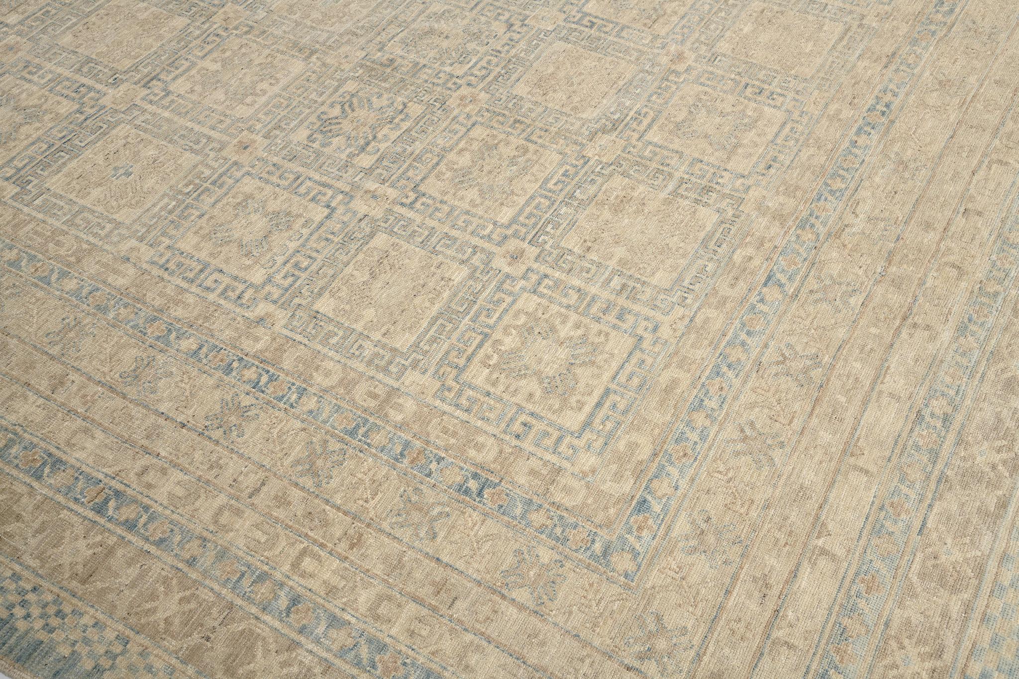 This incredibly woven Khotan revival rug showcases the symmetrical patterns that are simultaneously displayed all over the magnificent sandy field resulting in a breathtaking impression of creativity in the traditionally represented motifs. Dreamy