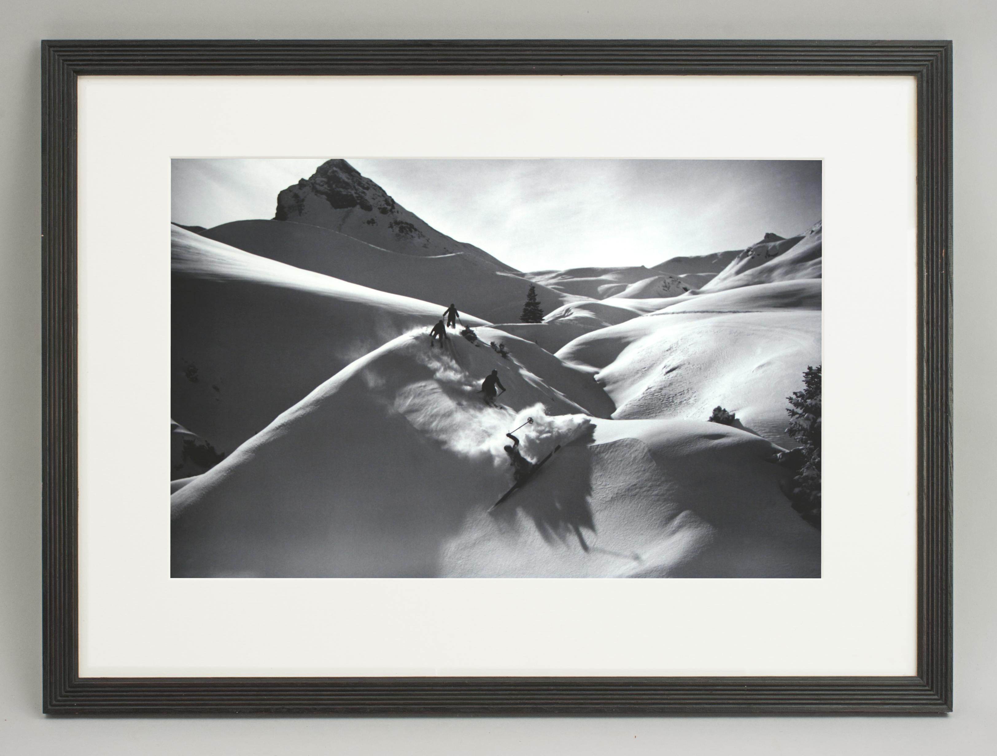 'VIRGIN POWDER', a modern framed and mounted black and white photograph after an original 1930's skiing photograph. The frame is black with a burgundy undercoat, the glazing is clarity+ premium synthetic glass. Black & white alpine photos are the
