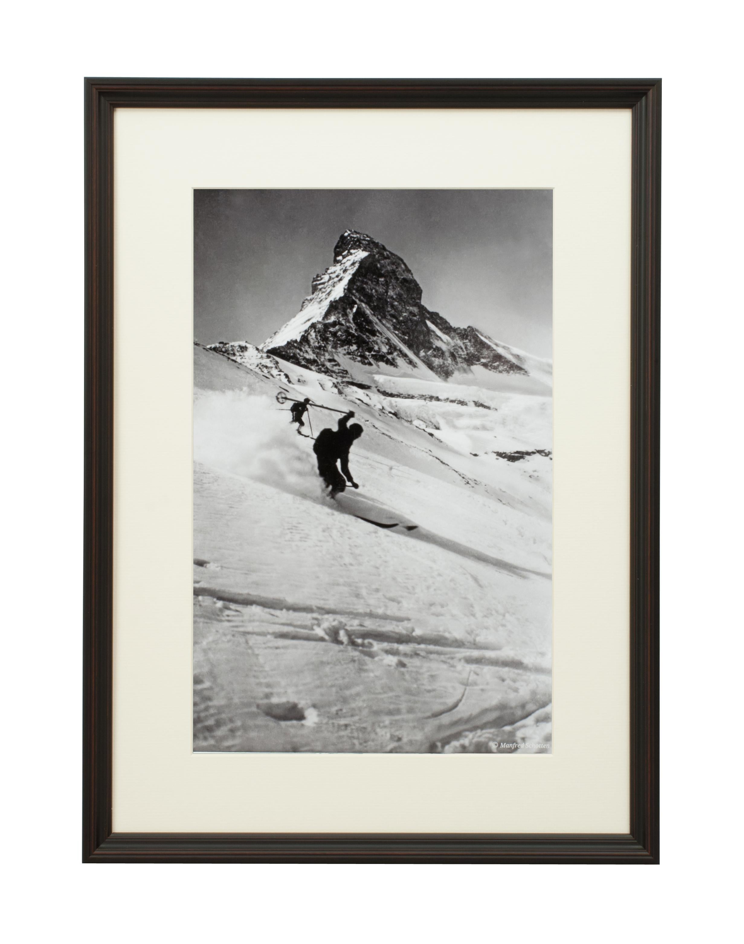 Vintage style ski photography, framed Alpine ski photograph, Matterhorn & Skiers.
'MATTERHORN & SKIERS', a modern framed and mounted black and white photograph after an original 1930's skiing photograph. The frame is black with burgundy undercoat,