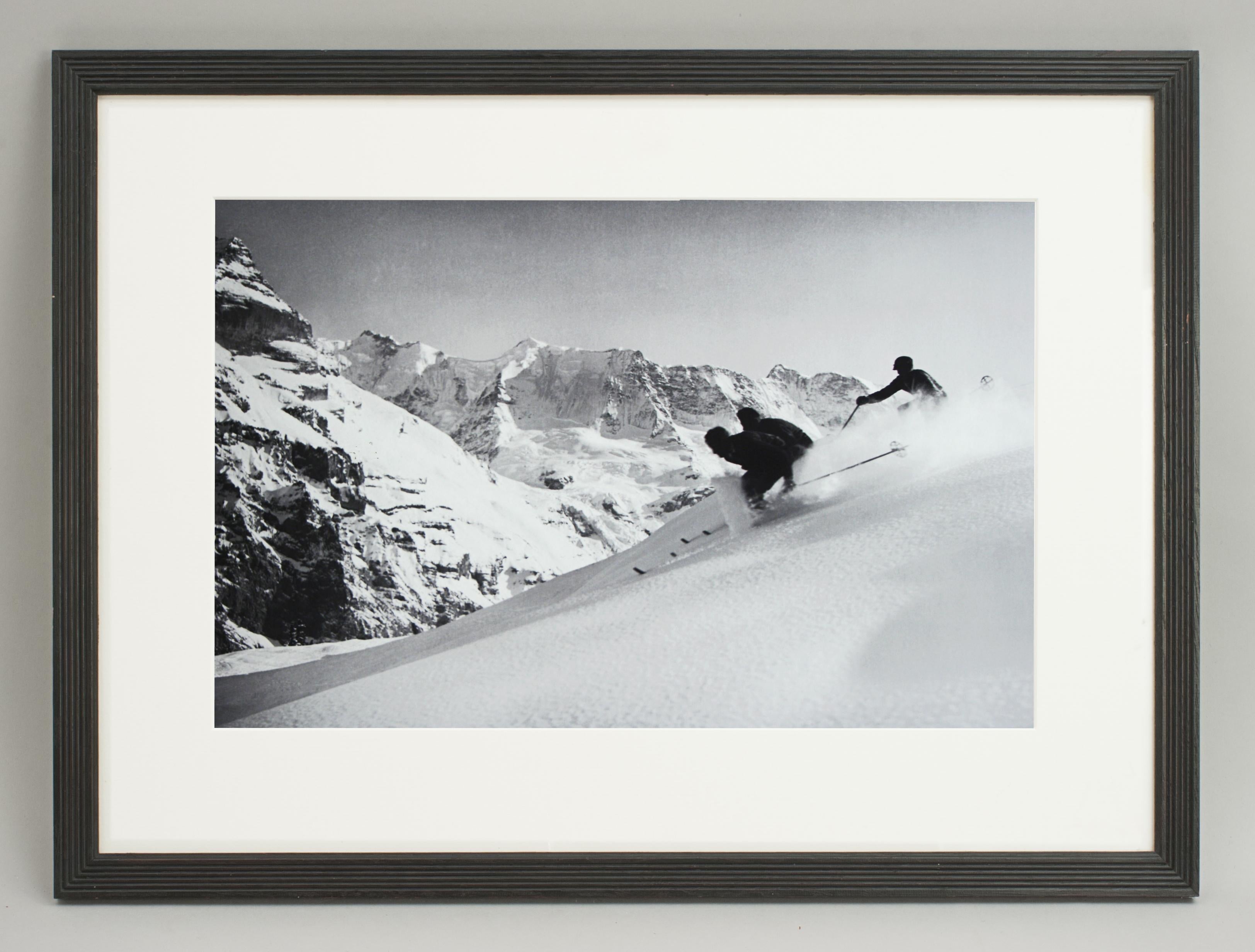 'SCHUSS' Murren, Switzerland, a framed and mounted black and white photographic image after an original 1930s skiing photograph. The frame is a hand colored reeded wooden black frame. Black and white alpine photos are the perfect addition to any