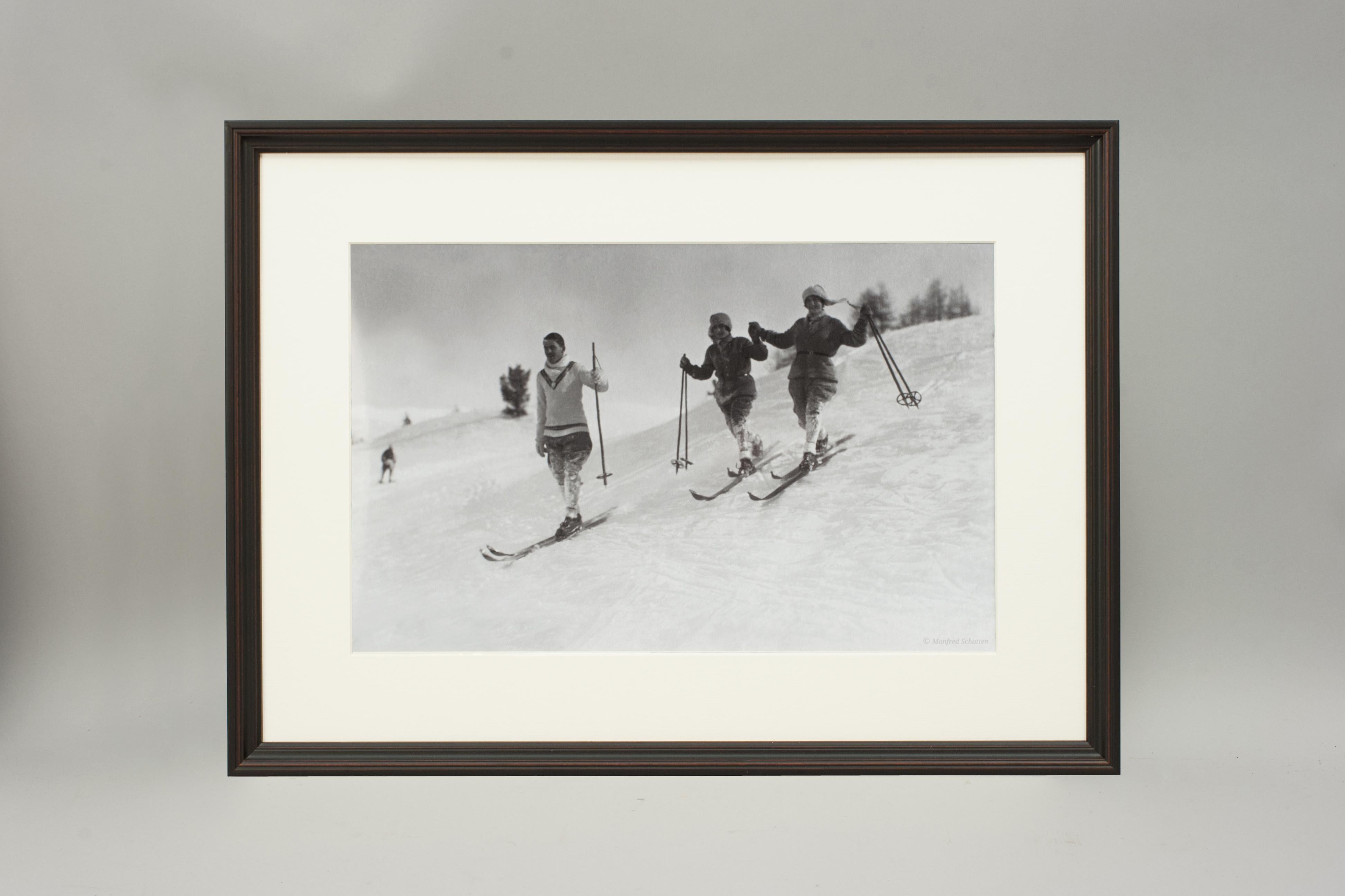 'St. MORITZ', a modern framed and mounted black and white photograph after an original 1930's skiing photograph. The frame is black with a burgundy undercoat, the glazing is clarity+ premium synthetic glass. Black & white alpine photos are the