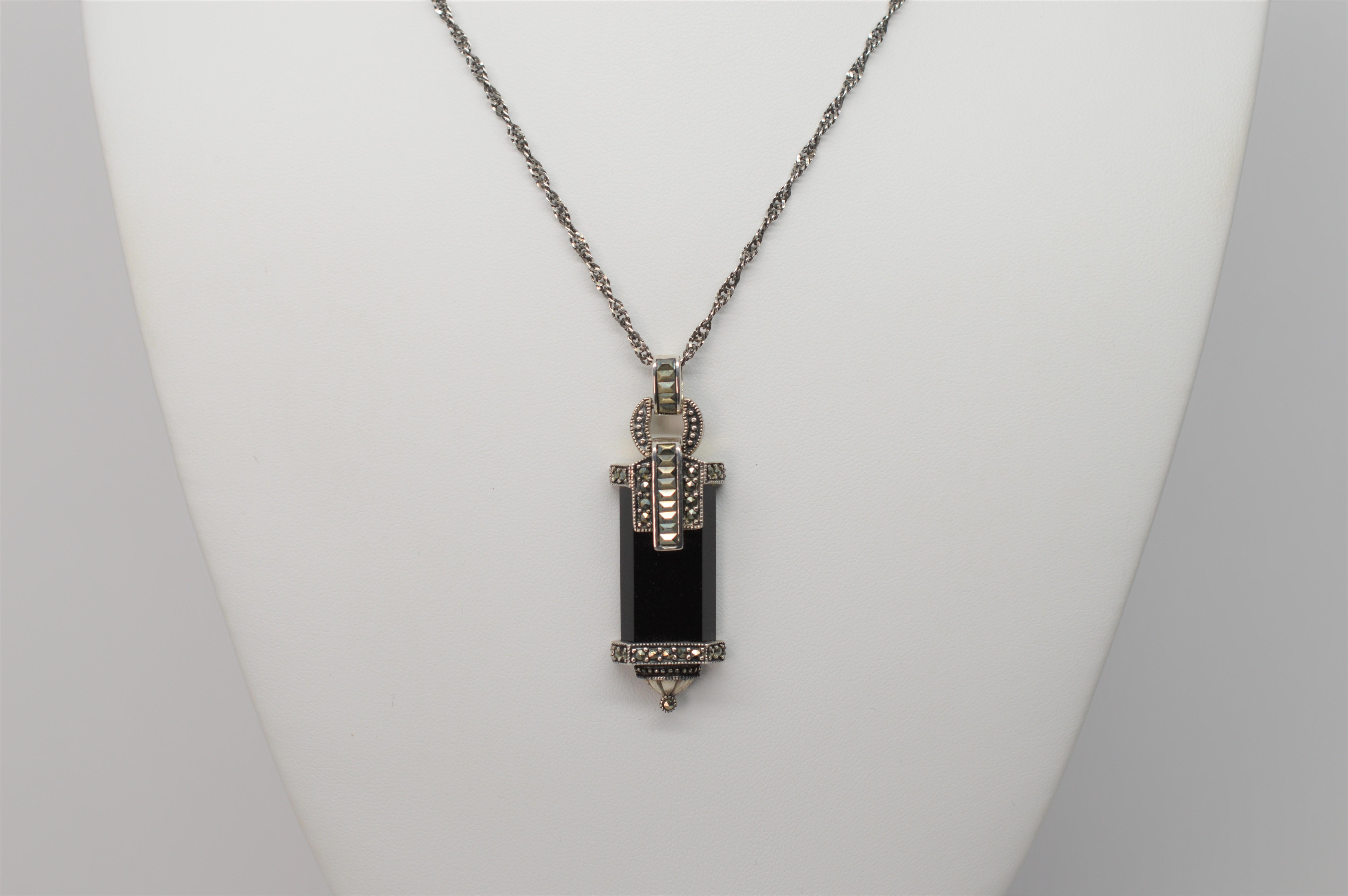 This twenty-eight inch Sterling Silver Chain leads to this attractive vintage-style reproduction Sterling Silver Marcasite Black Glass Pendant, made in Thailand. The pendant measures approximately 1-3/4 inch in length and 1/2 inch wide.  The artful