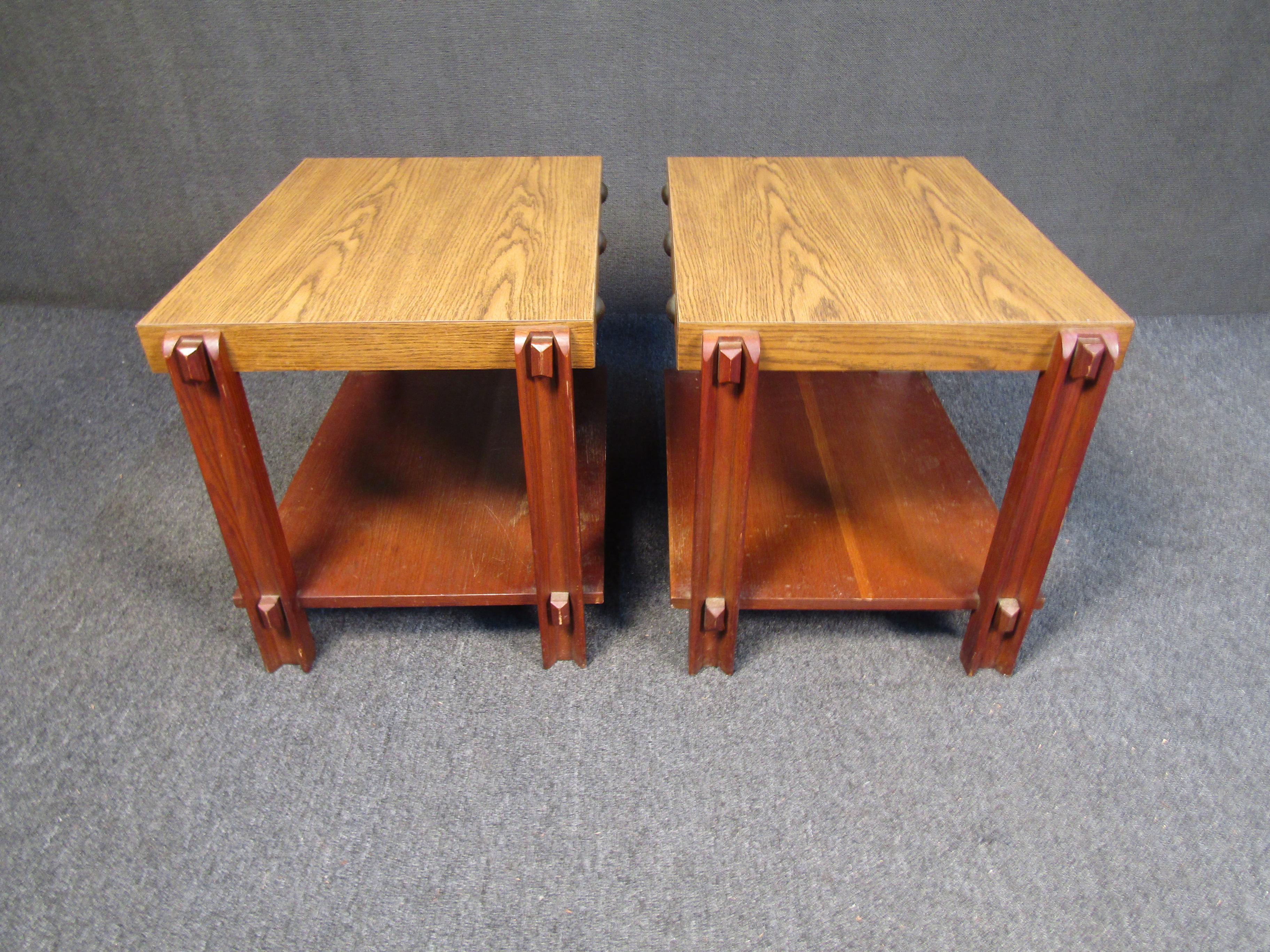 Pair of unique studded two tier end tables comes with a bicolored scheme sure to pop. These pieces are made of veneer and stand at 21 inches high. Please confirm item location (NJ or NY).