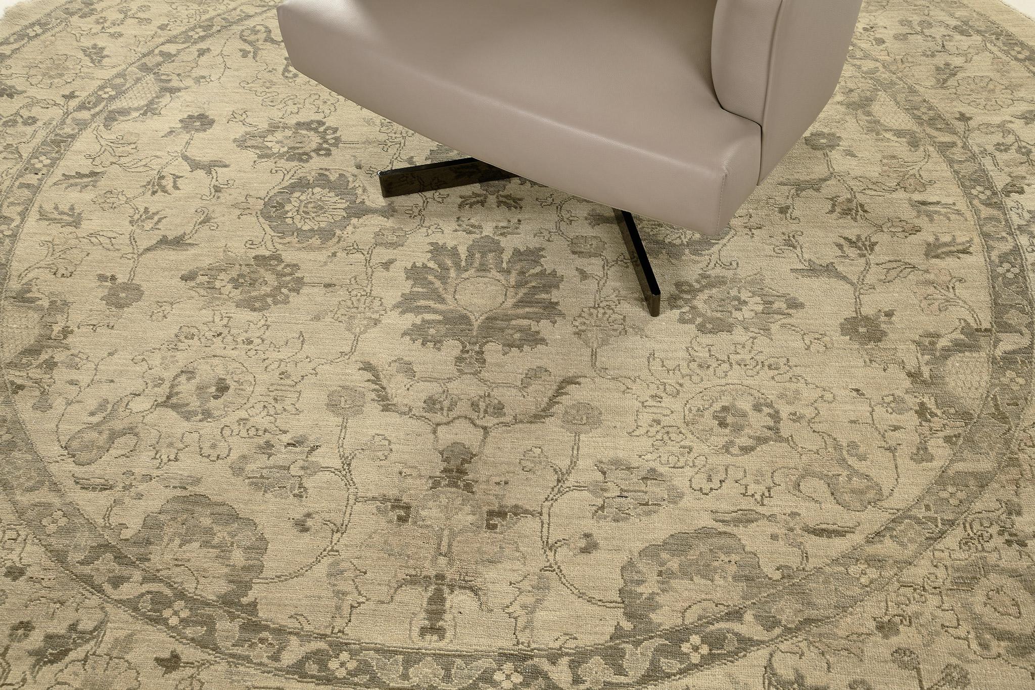 This stylish revival of the round rug was made from hand-spun wool and woven meticulously all the blooming palmettes, leafy tendrils, and stylized florid borders surrounded by symmetrical floral elements. A natural hue gives a breath-taking to every