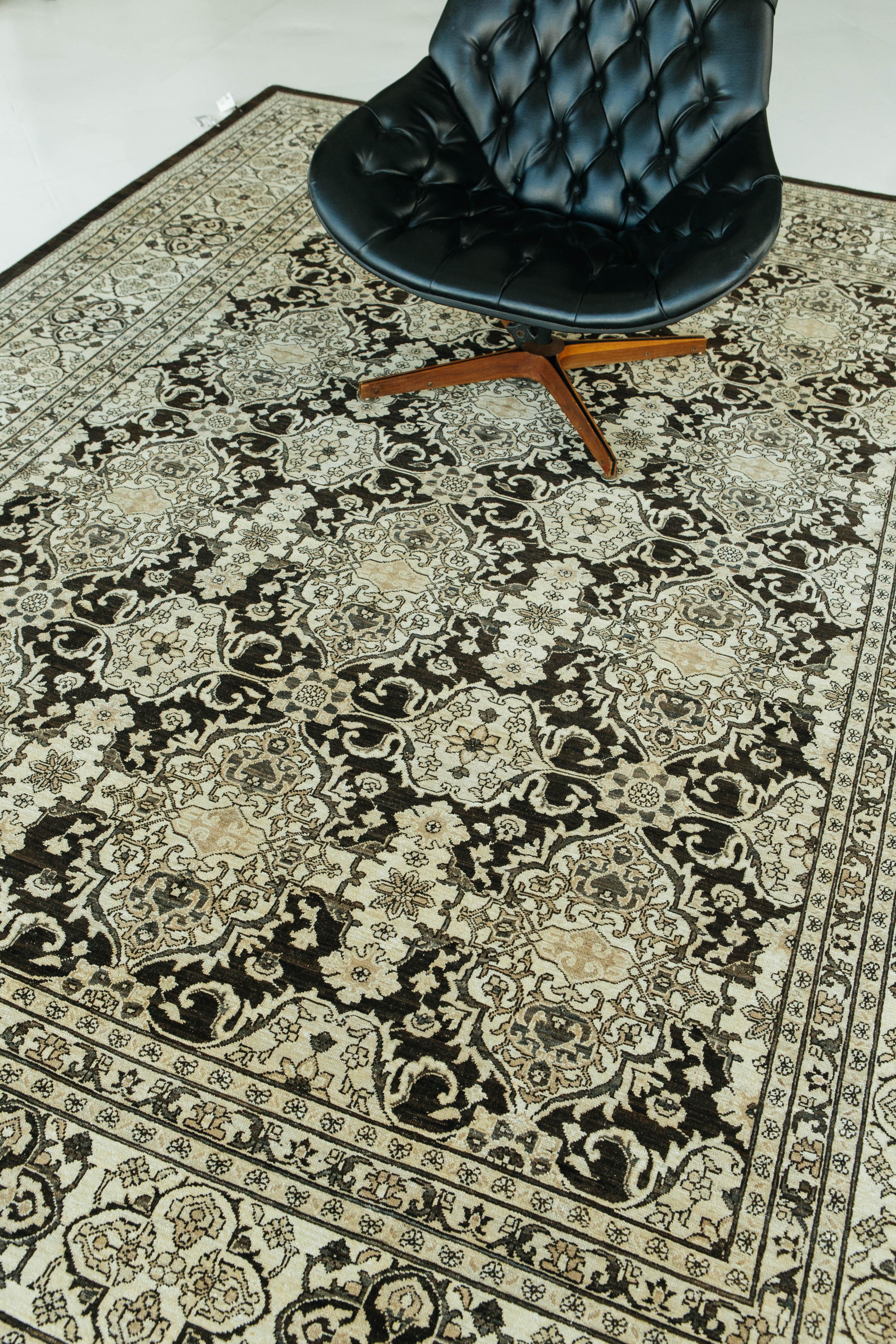 The vintage style black and white Tabriz recreation is nothing shy of luxury and elegance. This traditional recreation encompasses beautiful floral scrolls and traditional jewel-like Persian motifs in the center field. This rug will elevate any