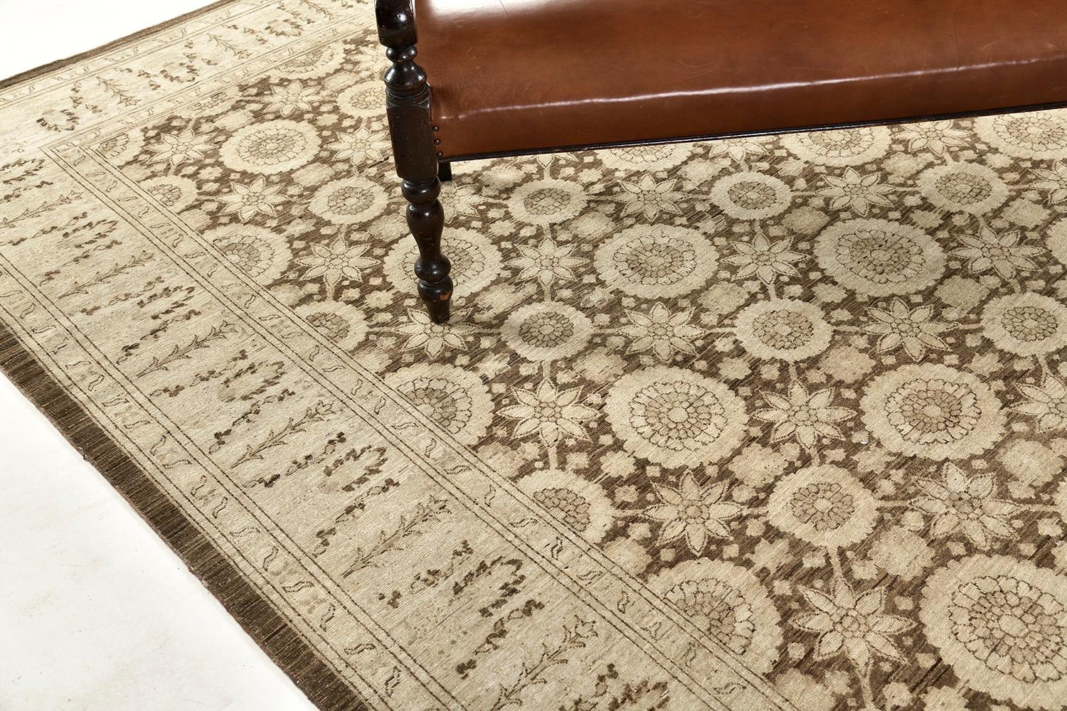 An elegant revival of Hadji Jalili has a neutral ground with cream and tan motifs that are accentuated with walnut-colored outlines. An all-over pattern that has finely rendered motifs of branching vines, palmettes, carnation, and leaf and floral