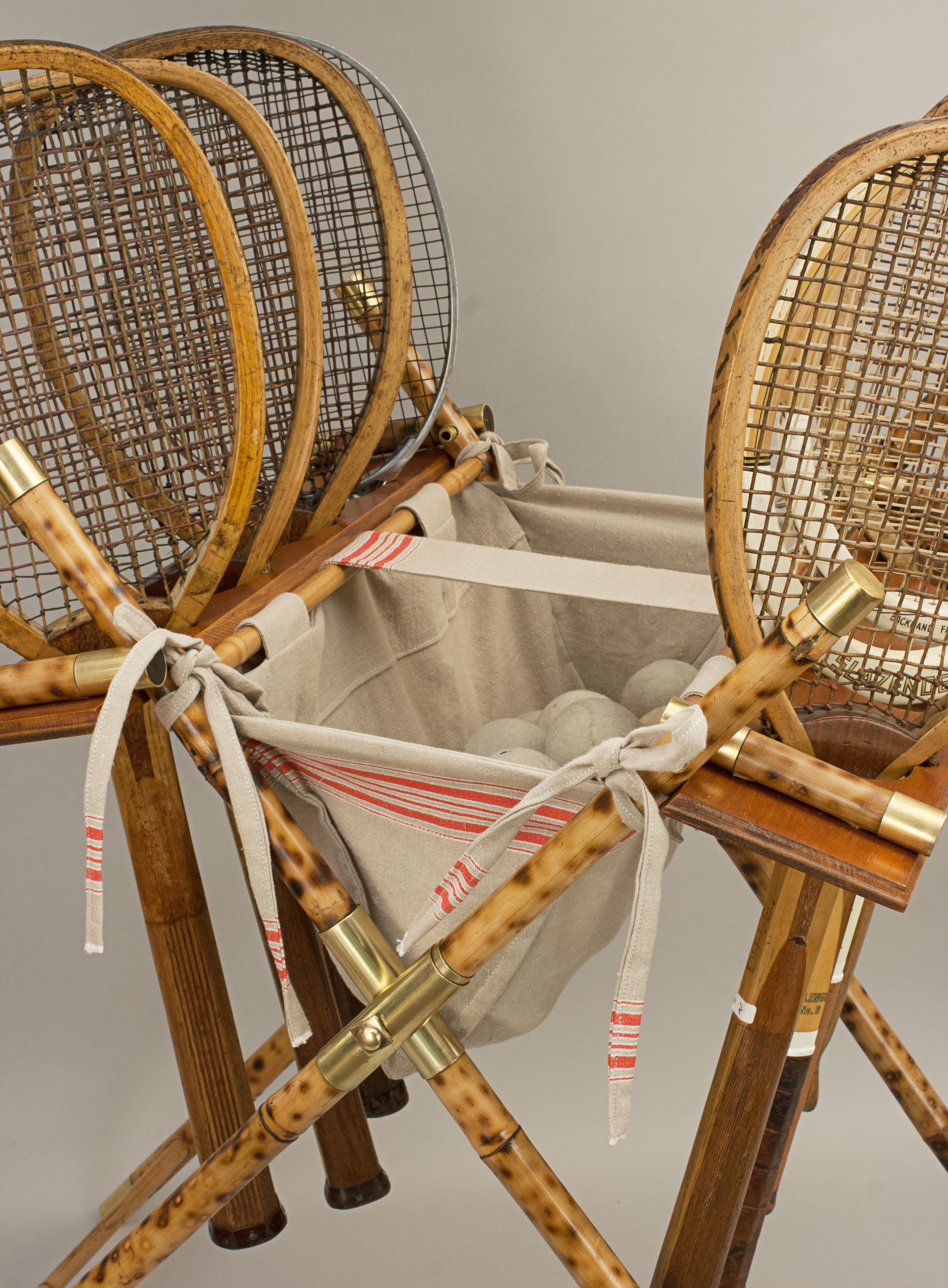 Lawn Tennis Racket Display Stand, Ball Hopper.
A wonderful stand for lawn tennis rackets and balls. The stand is made of beautifully marked bamboo with brass fittings and a cloth ball bag (hopper). It can display eight rackets within the mahogany