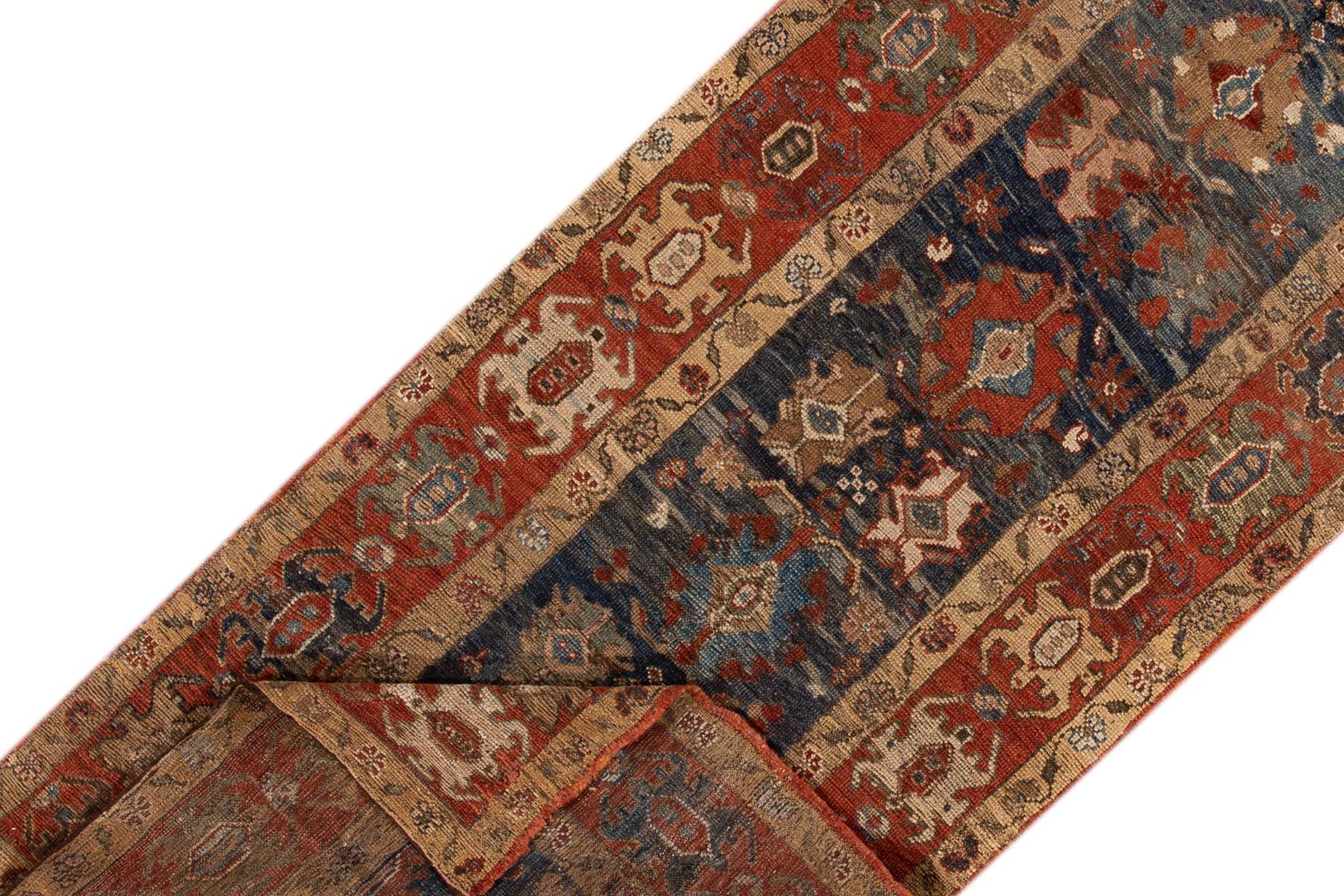 Vintage hand-knotted Persian Bakshaish Runner with a navy-blue field, the frame of rust, and beige accents in all-over tribal design. This piece has fine details, great colors, and a beautiful design.

This rug measures 3'11