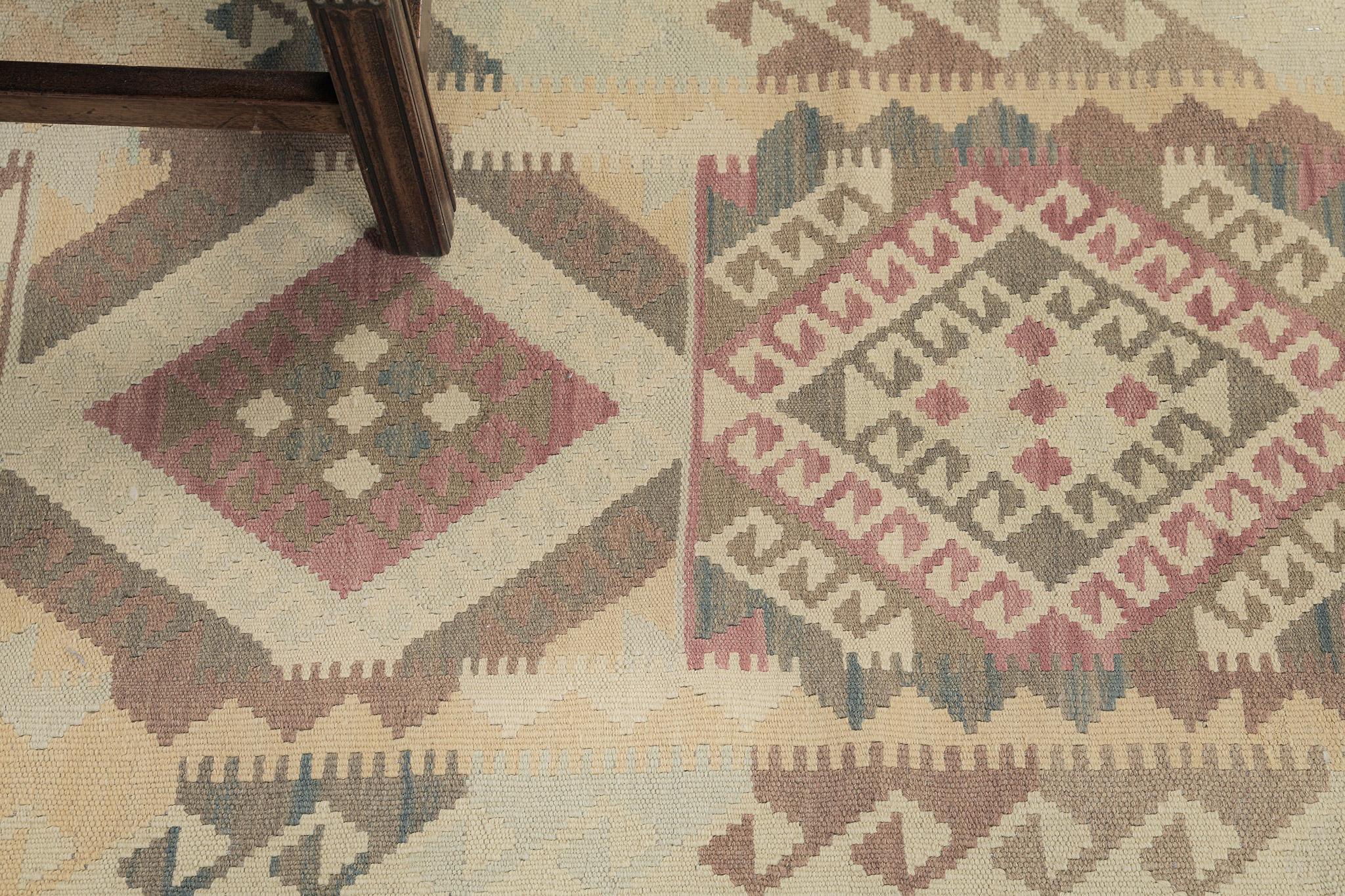 A stunning vintage-styled flatweave Kilim is surrounded by a water motif. The tribal motifs are in diamond patterns that create a festive and interesting design for a large variety of interiors. A masterpiece that will set your interior more