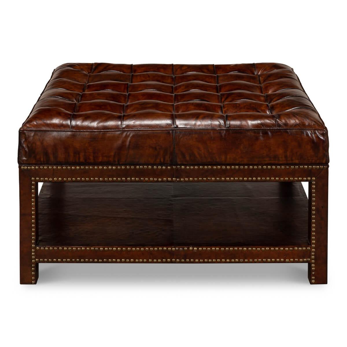 Vintage-style leather tufted ottoman in brown leather. It features a solid hardwood frame wrapped in rich brown leather detailed with nailhead brass trim. The cushioned top is fixed to the base with a tufted button pattern. 

Dimensions: 36