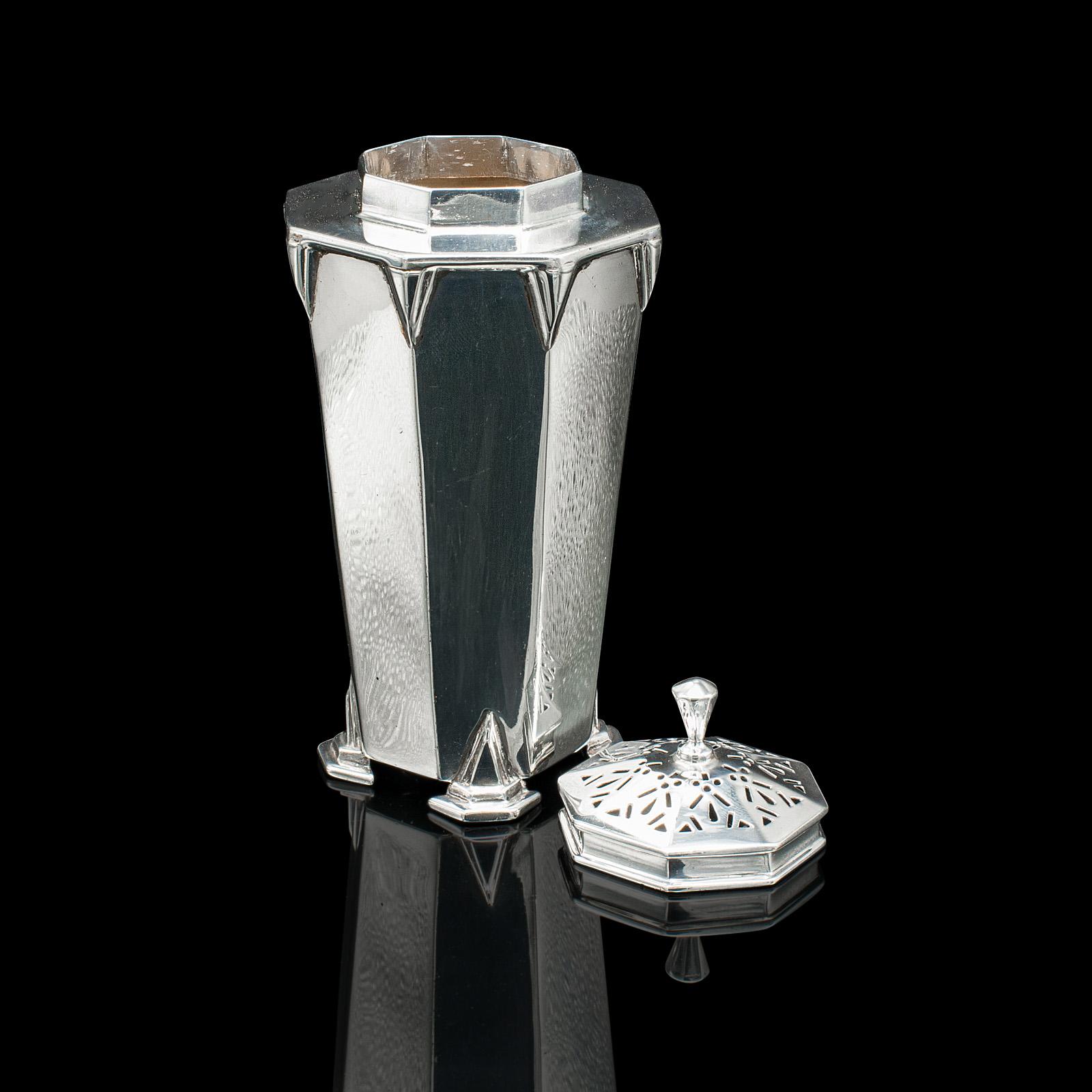 This is a vintage sugar caster. An English, sterling silver shaker in Art Deco taste, hallmarked 1933.

Fascinating Art Deco silverware, with a fine appearance
Displays a desirable aged patina and in good order
Sterling silver presents great