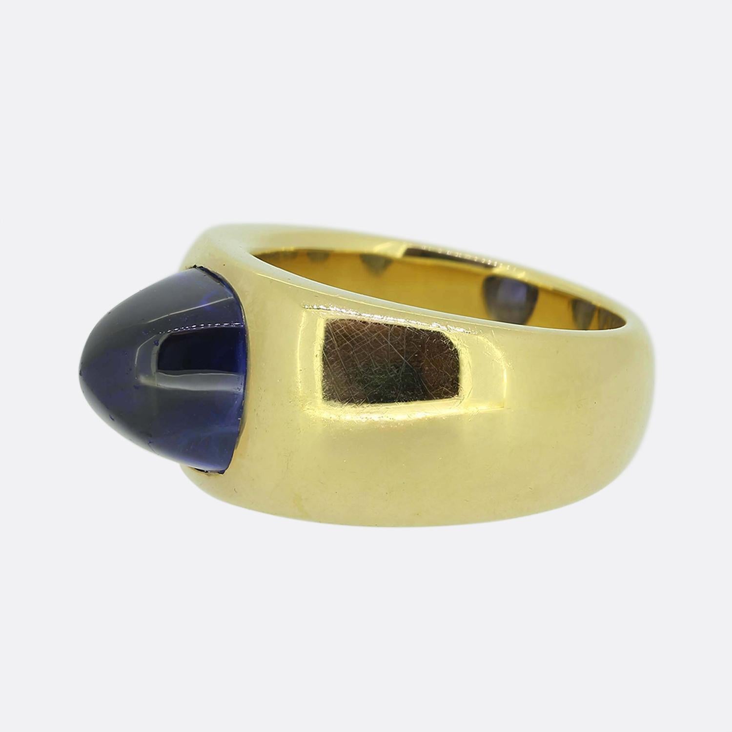 Here we have a gorgeous single stone sapphire ring. This piece has been crafted from a warm 18ct yellow gold and showcases a single sugar loaf sapphire at the centre possessing a gleaming mid-night blue colour tone. This dusky blue stone has been