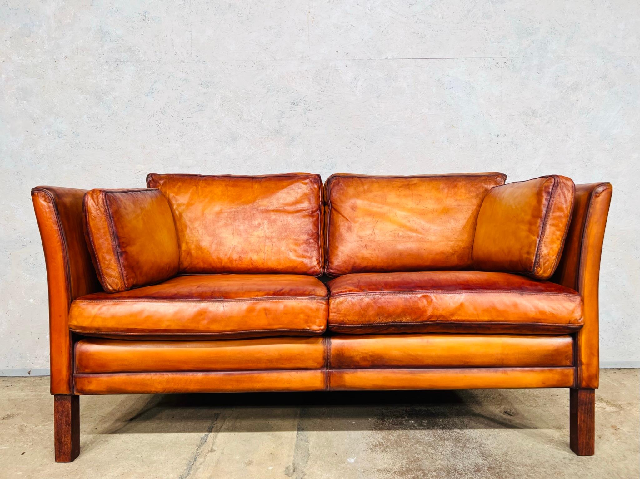 A stylish matching two seater and three seater Danish 1970s sofas designed by Mogens Hansen, great design with beautiful lines, they sit wonderfully together.

The leather has a stunning hand dyed light tan colour with great patina and