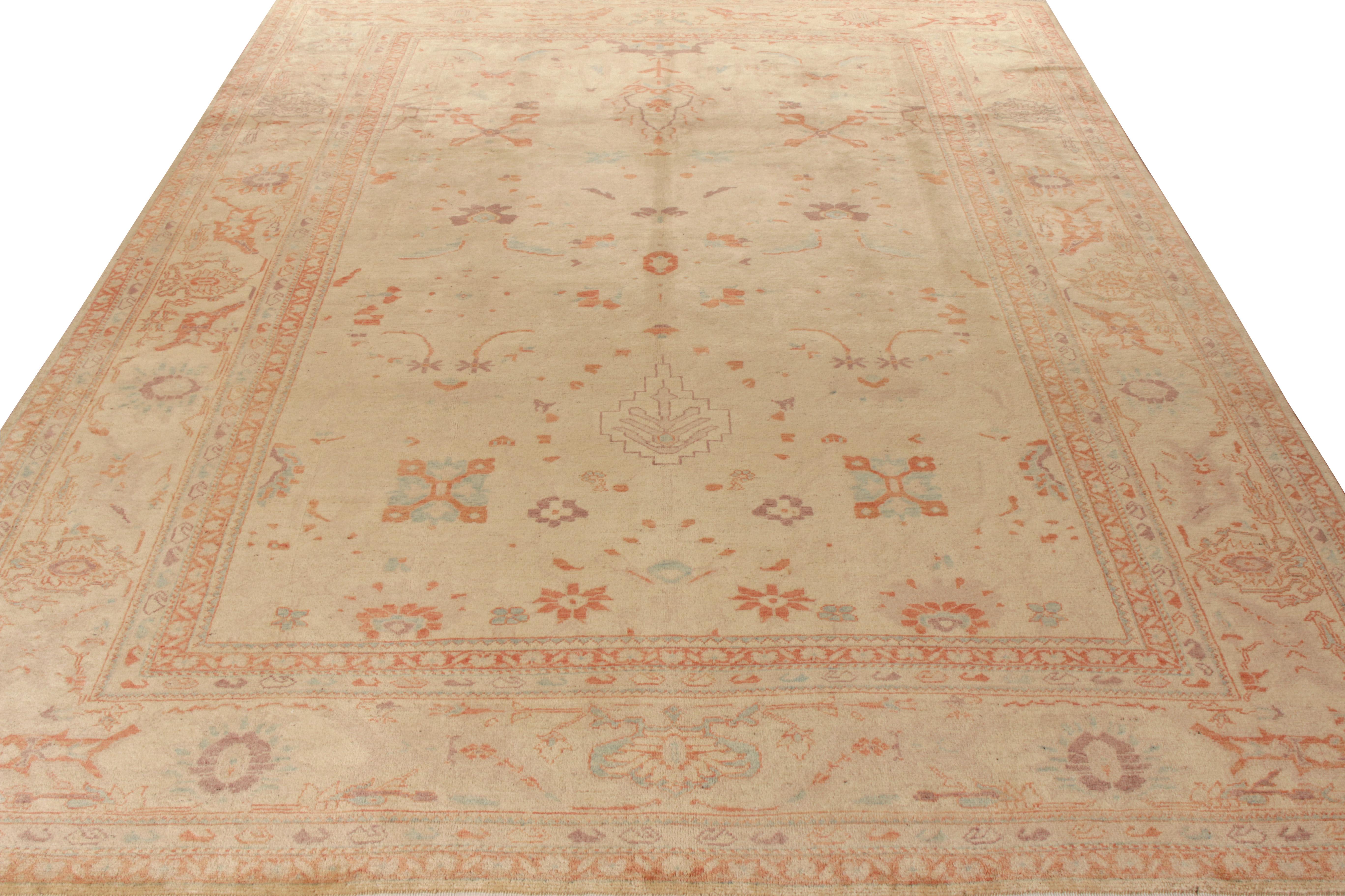 A 10 x 12 vintage Turkish Sultanabad style rug in beige and orange from Rug & Kilim’s Modern Classics Collection. Hand knotted in wool, the rug is an exceptional modern sketch from the works of George Ravmamovich, revelling in regal floral patterns.