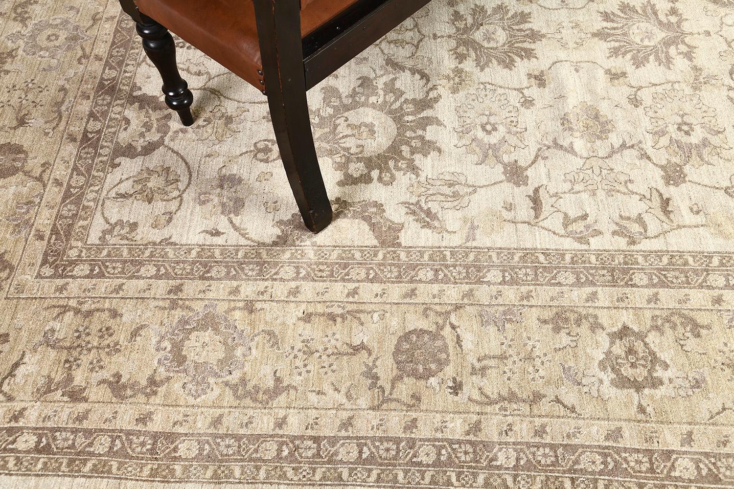 A soft version of the Sultanabad vintage style rug features an all-over design of palmettes, vine scrolls, and leafy tendrils. Stunning wool woven in neutral tones enhanced the whole artistry of this creation. Stylized motifs of the borders add