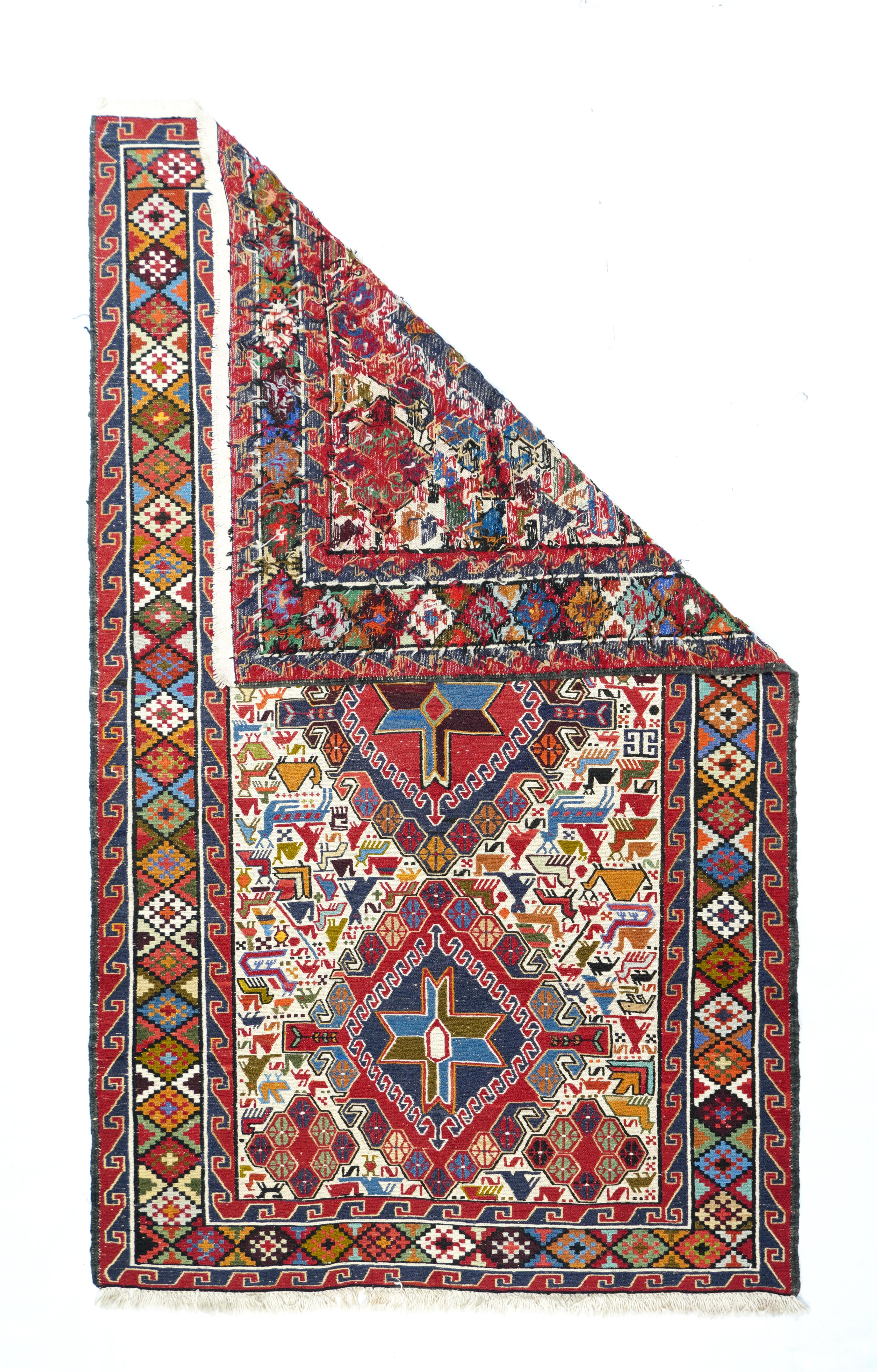 Vintage Sumak Rug 4' x 6'7''. The ecru field shows three hooked diamond medallions wit interior stars and scrolling boteh edges, all surrounded by birds and animals including dromedaries. Dark brown strip-style border with colorful nested stepped