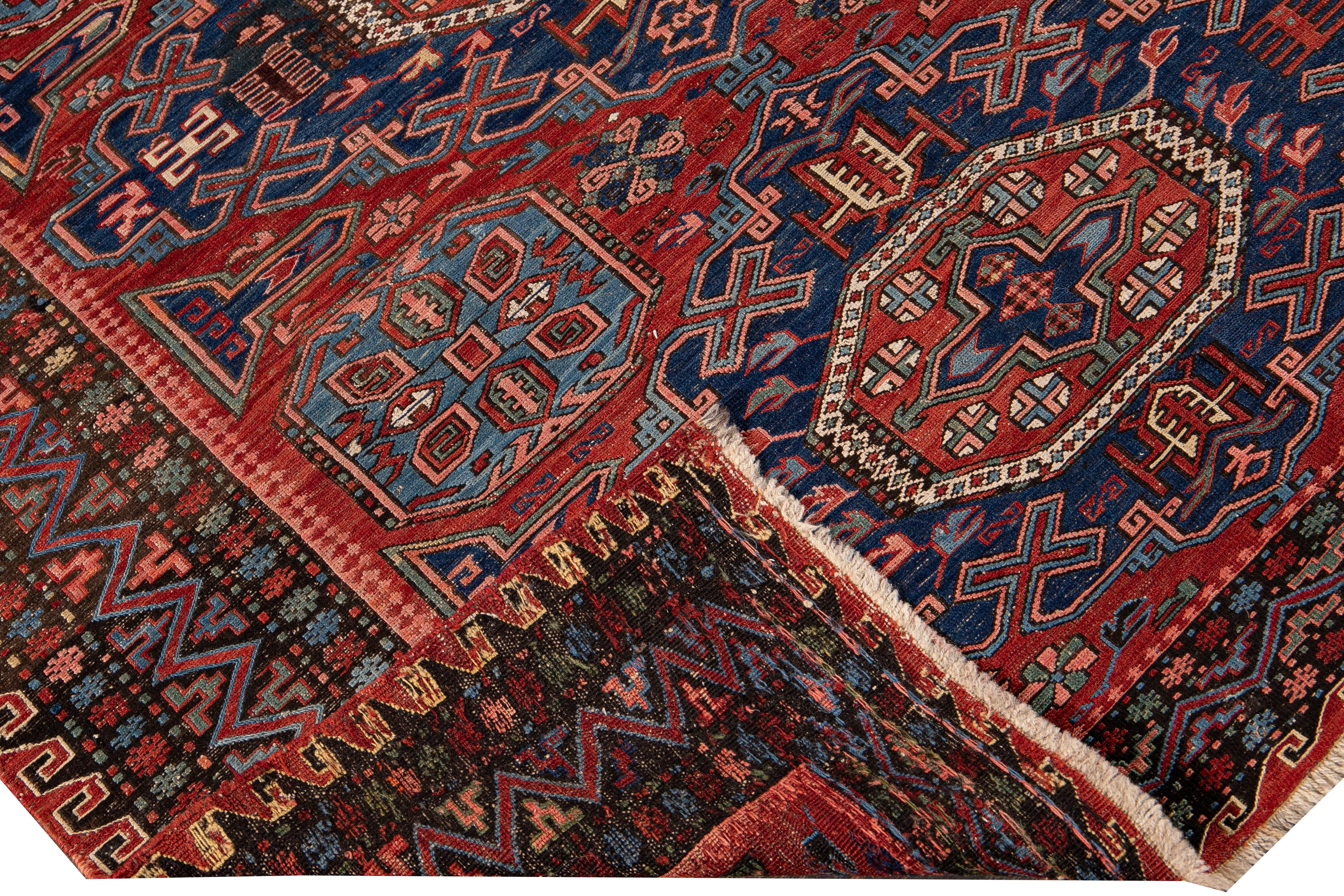 Beautiful vintage Sumakh hand-knotted wool rug with a red and blue field. This Sumakh rug has multicolor accents in a gorgeous all-over geometric medallion motif design.

This rug measures 5' x 6'9