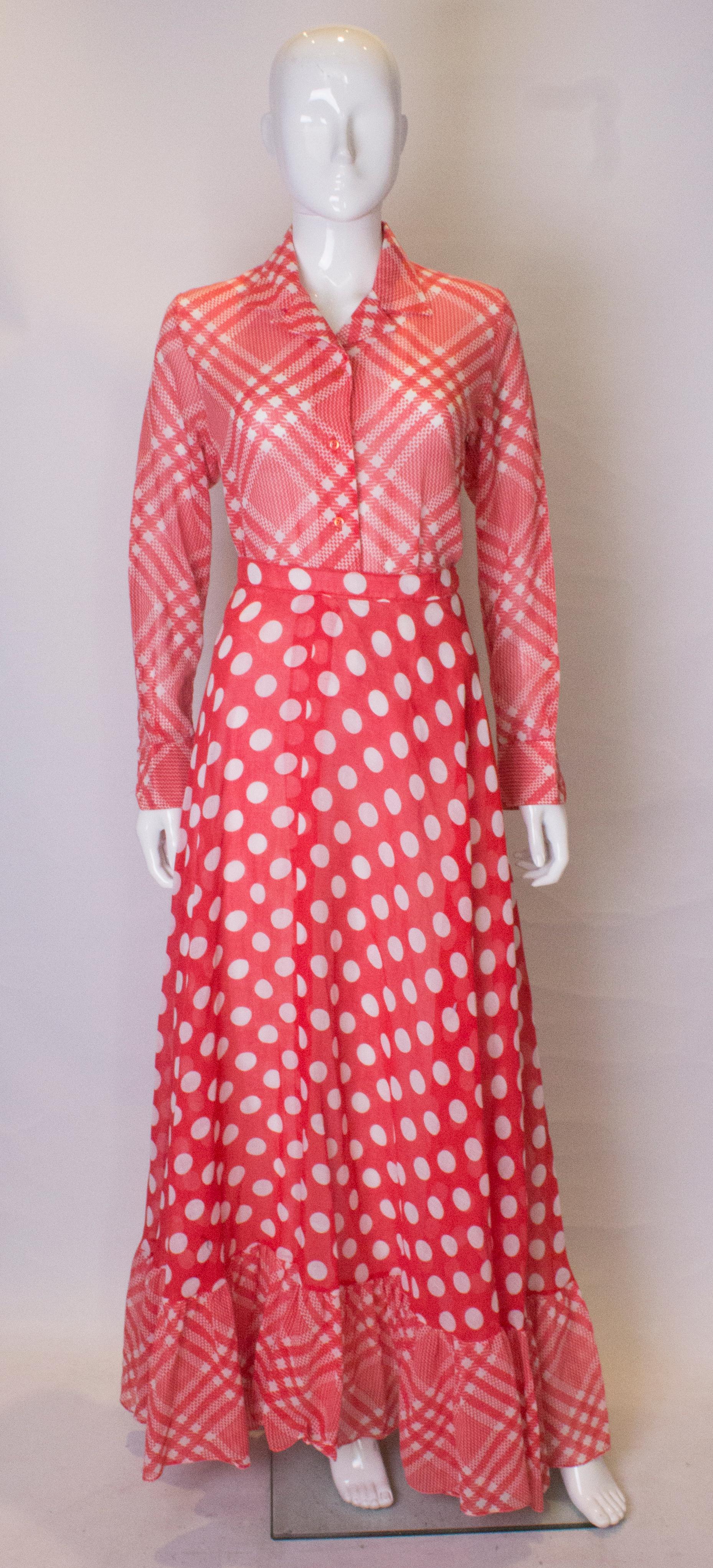 A chic two piece for Spring /Summer.  The shirt has a cut away collar and button opening front  and cuffs, in an attractive red and white check.  The full  length skirt is lined, and has a polka dot body and check frill at the hem.

Measurements: