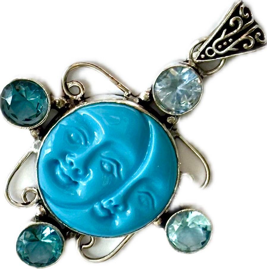 Superb Turquoise Pendant featuring sun and moon design, adorned with blue aquamarine gemstones and silver filigree. This pendant, made from 925 sterling silver, showcases a detailed carving of a sun and moon face, symbolising the duality of life.