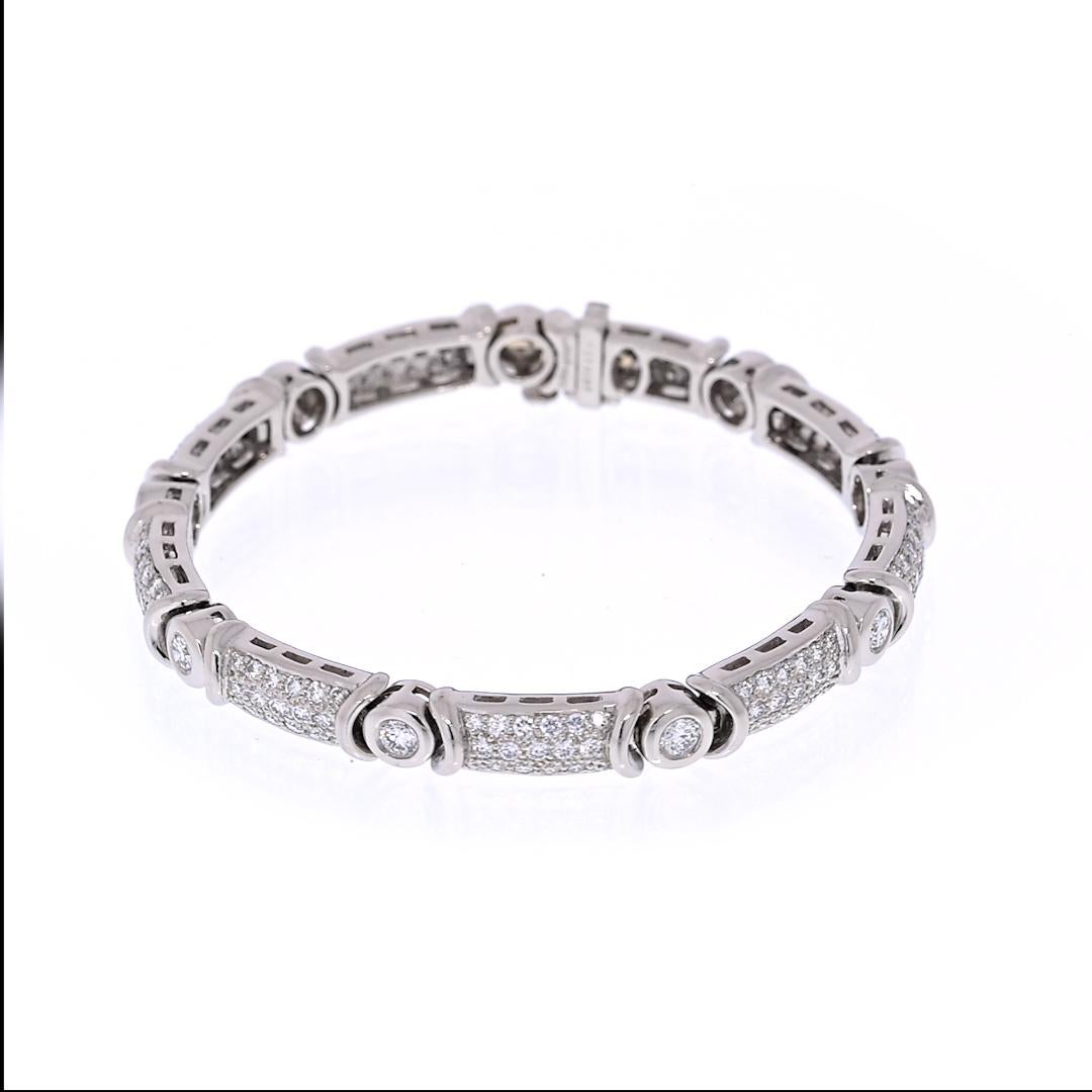 Platinum bracelet set with nine round brilliant cut diamonds in connector links, each .22 carat, 1.98 CTW. SUNA signed and stamped. This Bracelet bears an additional one hundred fifty-three pave set diamonds, each 0.04-0.03 carat, totaling 4.59 CTW.