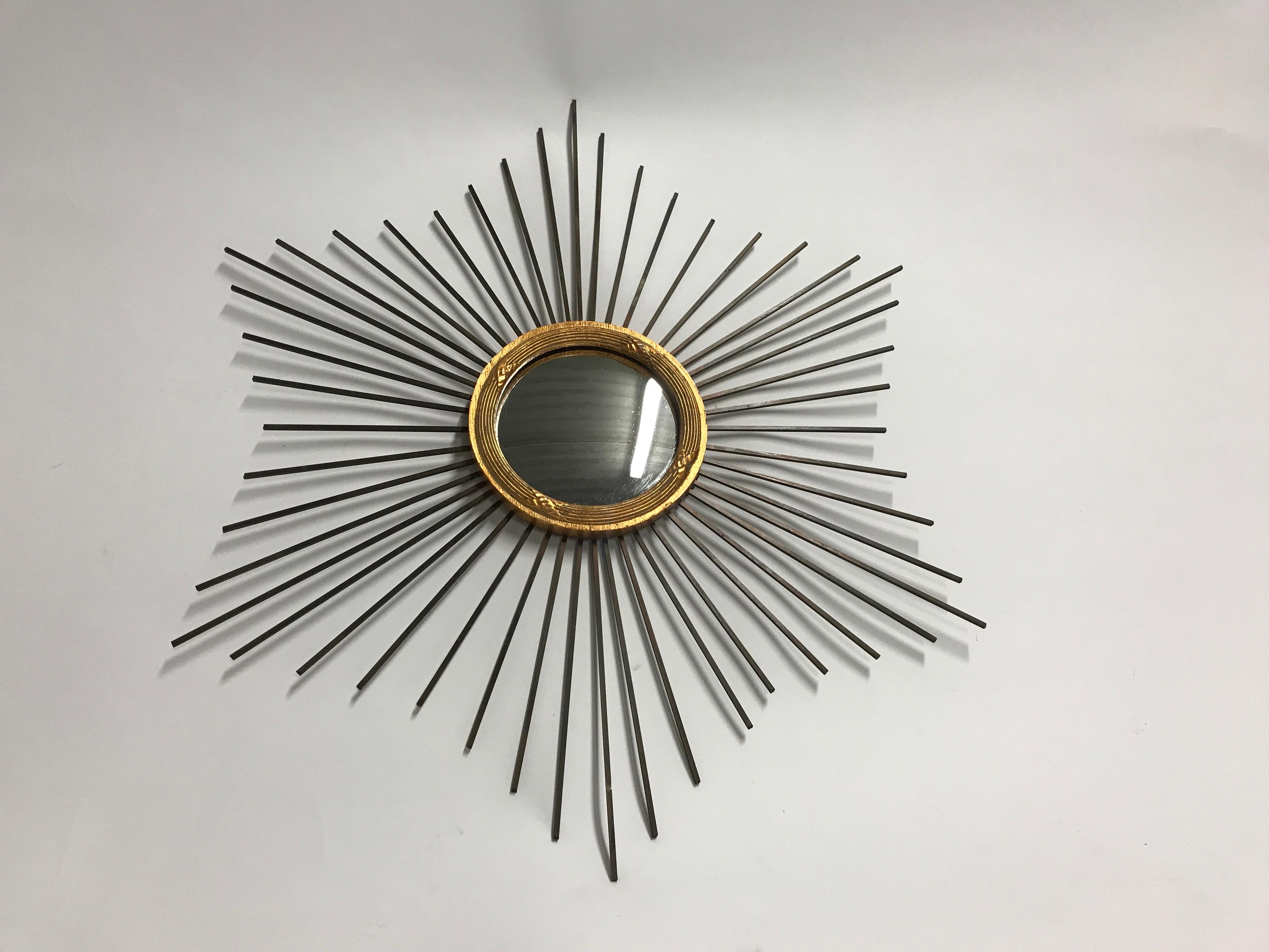 Charming vintage sunburst mirror with convex mirror glass. 

The Minimalist design makes it very useful in modern interiors.

Hollywood Regency style.

France, 1960s. 

Dimensions: 
Height 57cm/22.5”
Width 49cm/19.5”.

 