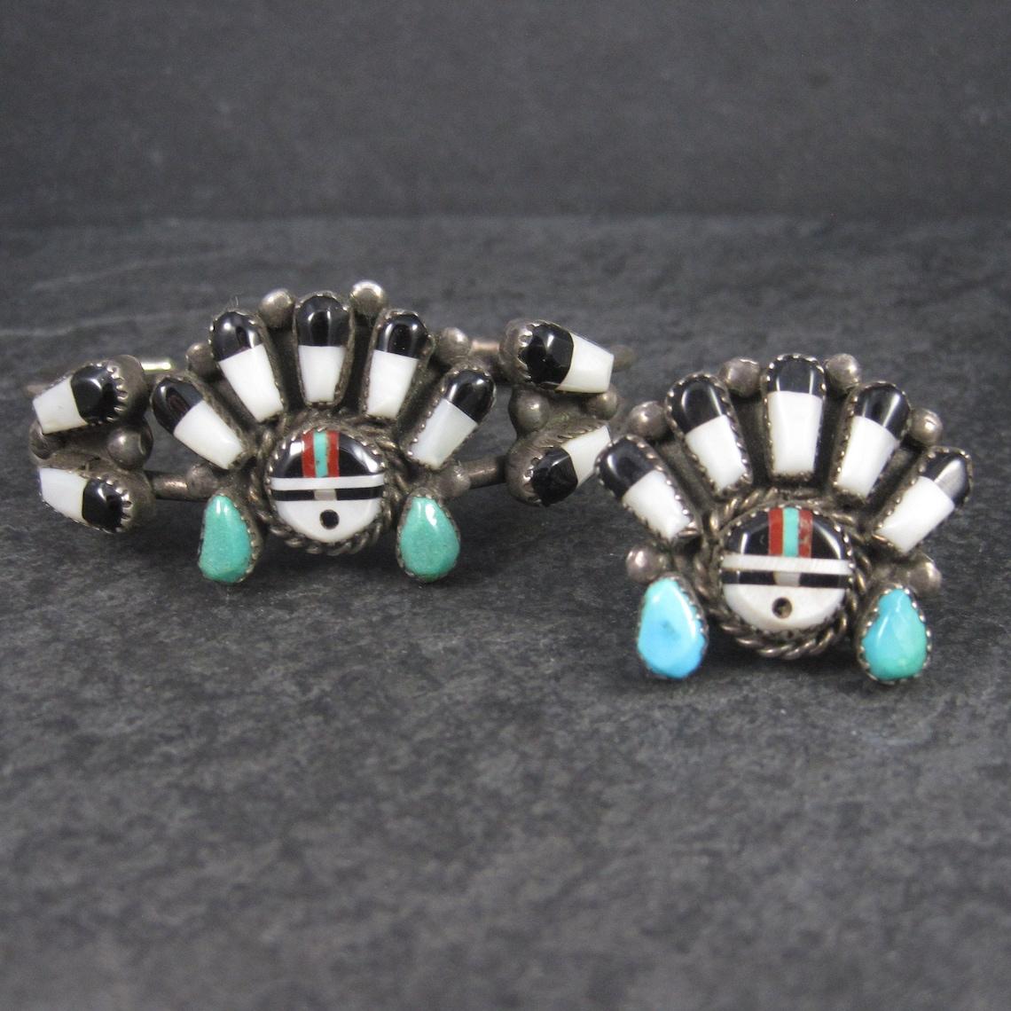 This gorgeous Native American Bracelet and Ring set is sterling silver.

Ring:
Features inlay in turquoise, mother of pearl, jet, and coral.
The face of this ring measures 1 1/8 inches north to south, 1 3/16 inches east to west with a rise of 5mm