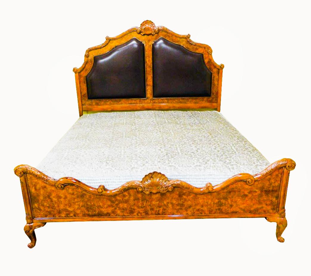 This is an exquisite vintage burr walnut serpentine Queen Anne Revival bed, dating from the late 20th century.

A lot of intricate detailing has gone into the creation of this stunning bed with a sumptuous Italian leather headboard, finely hand