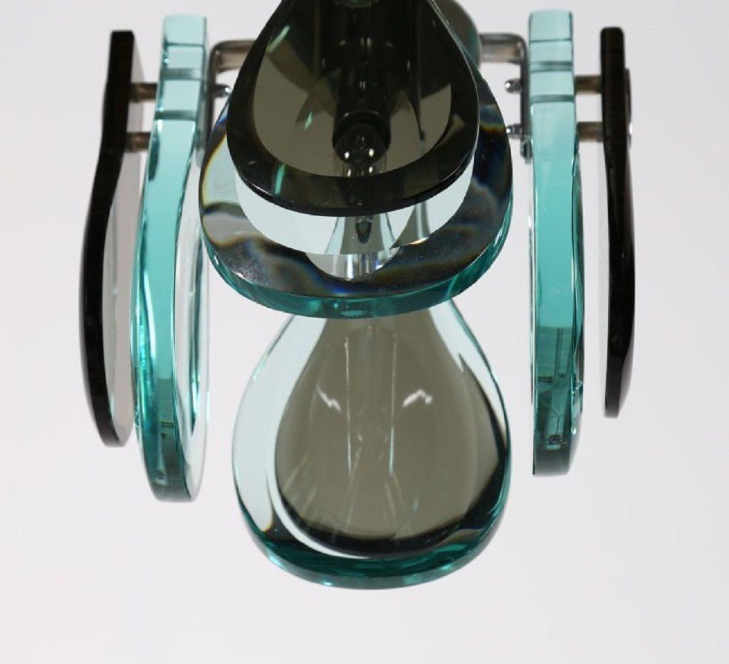 This suspended lamp is a design lamp manufactured in Italy during the 1970s.

Elegant suspended four-lights lamp in glass which create a brilliant combination of colors. 

Dimensions: cm 25 x 25 x 25.

In excellent conditions.