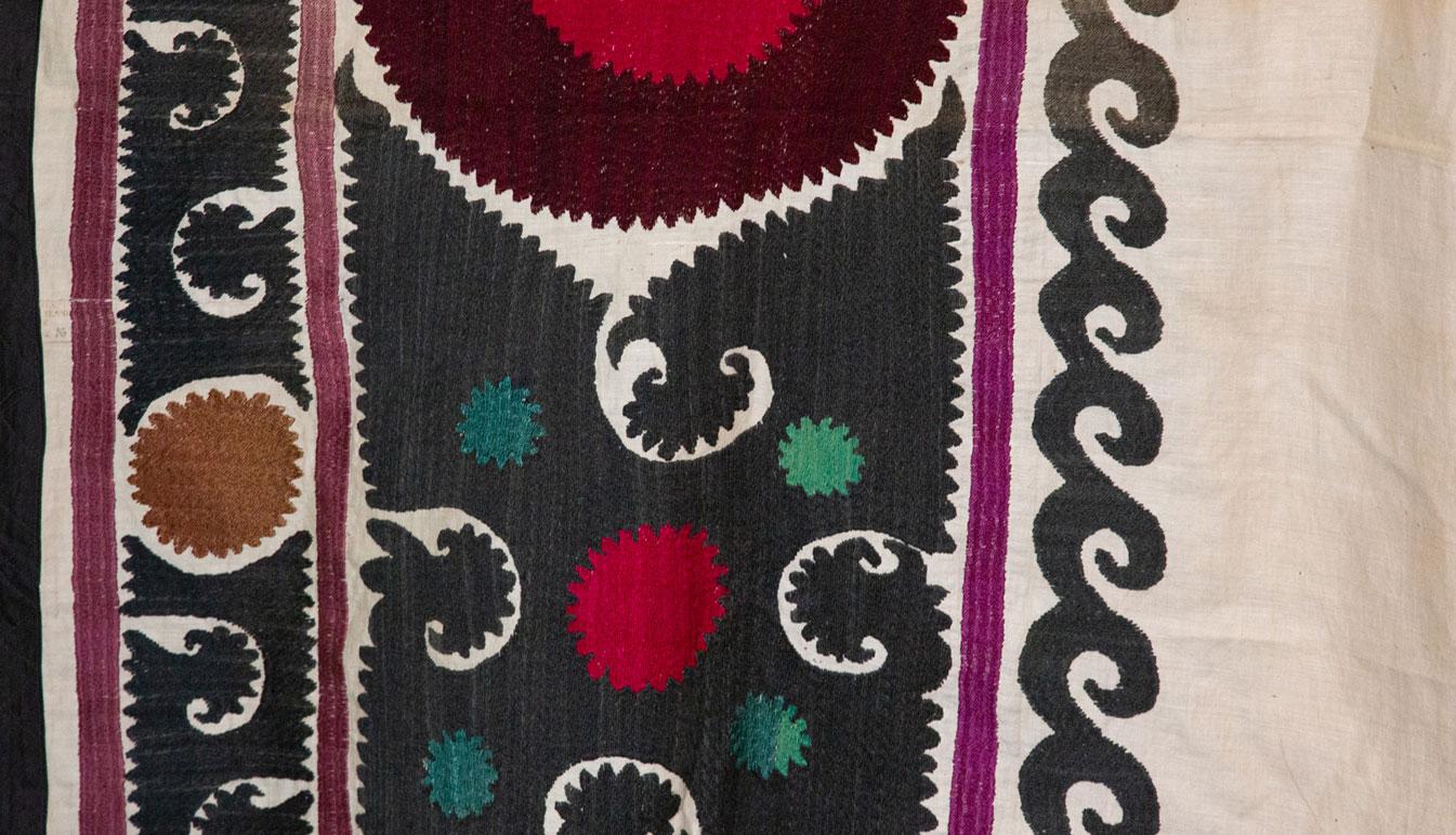 Vintage Suzani. Handmade vintage cotton Suzani with deep purple, dark green, black, and magenta. Measures: 68