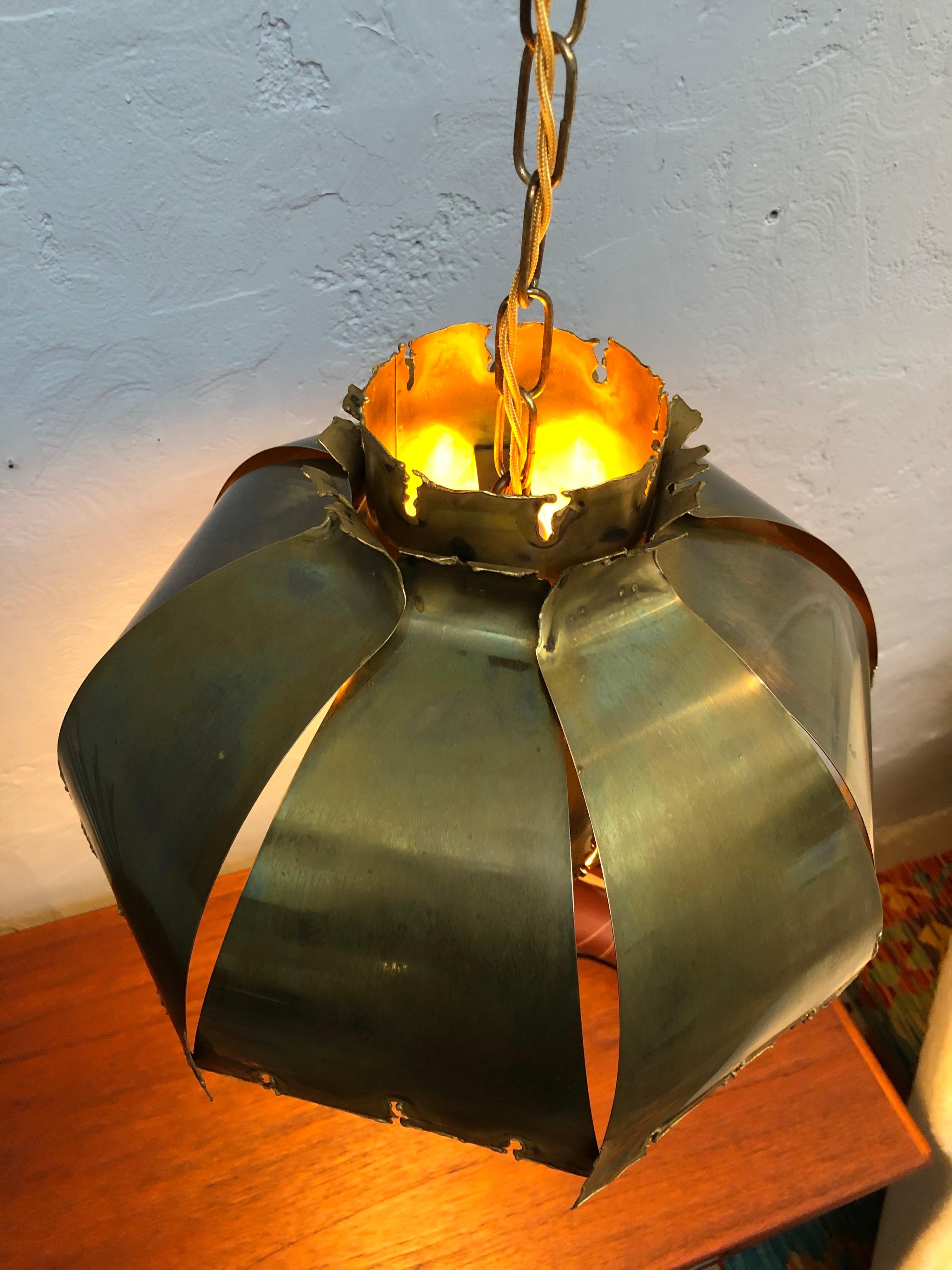 Vintage Svend Aage Holm Sørensen for Holm Sørensen & Co pendent chandelier lamp.
This classic piece of brutalist lighting is made up of two layers of torch cut brass.
The Danish designer Svend Aage Holm-Sørensen (1913-2004) possessed as an artist a