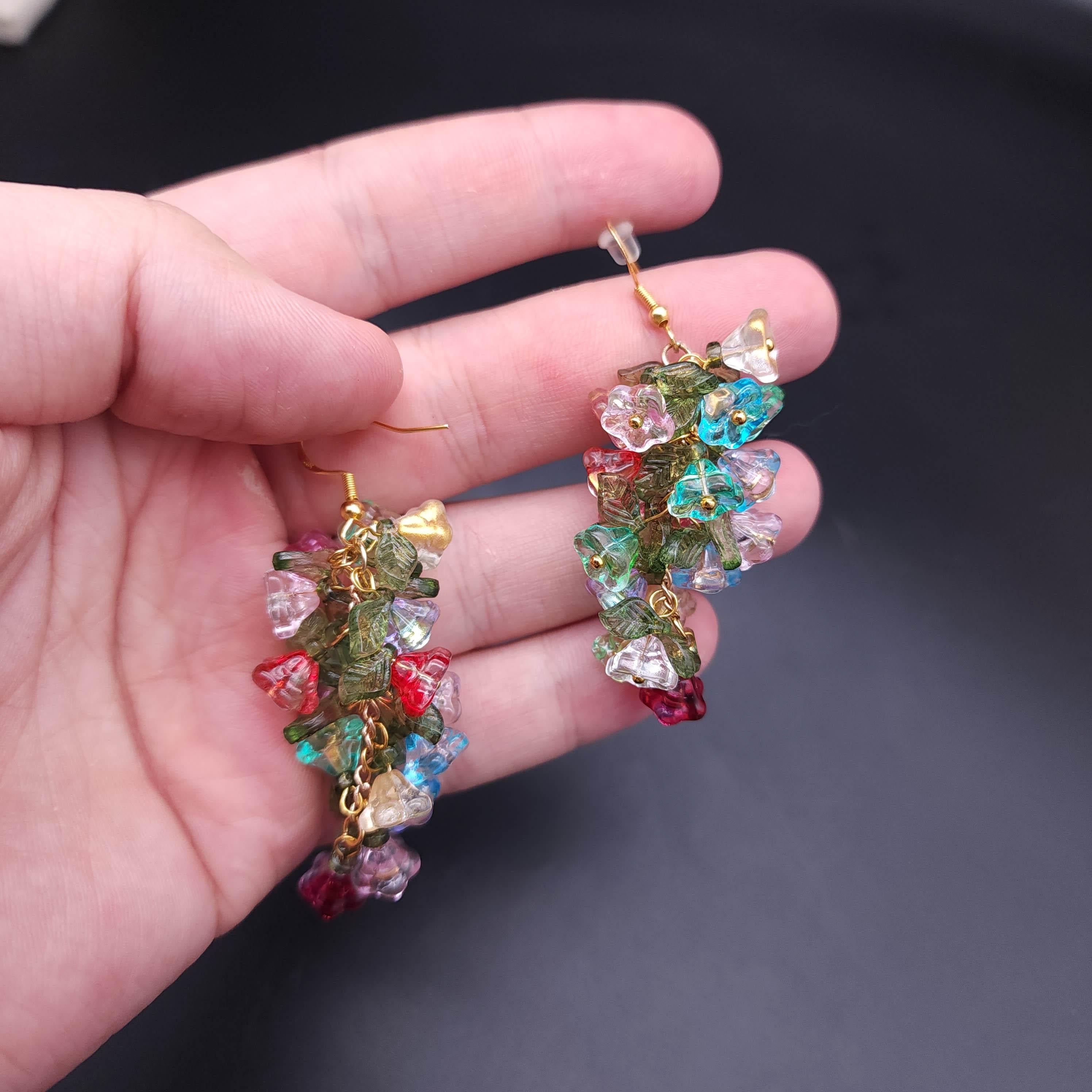 Add a splash of color and sparkle to your wardrobe with these stunning colorful Swarovski flower cluster dangle earrings. Each earring is a masterpiece, featuring a vibrant bouquet of Swarovski crystals that shimmer with every movement. These