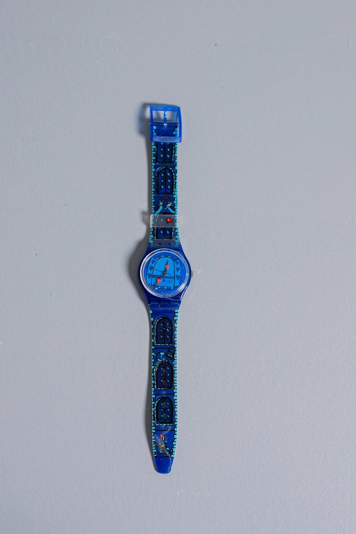 Swatch from the 2001 spring - summer collection dedicated to lovers. The watch has blue and light blue color comic-like designs on the strap and dial. The most beautiful feature are the hearts on the hands of the watch, as if to remind the wearer of