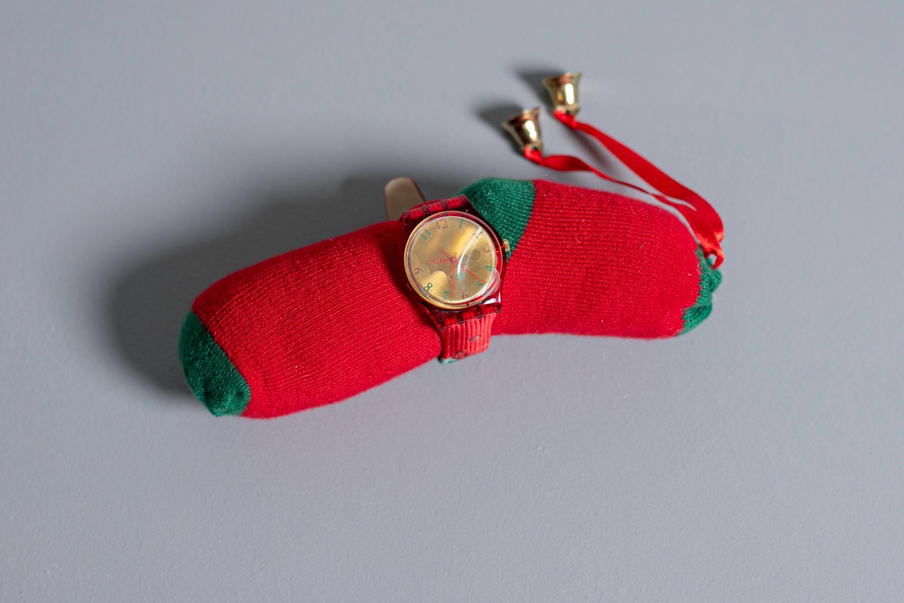 Beautiful Holly Jolly Swatch dedicated to Christmas holidays. The strap is made of leather and has a nice Christmas pattern. The box is made of wood and inside the clock is rolled up to a cute sock. 

Case material: Plastic
Strap Material: