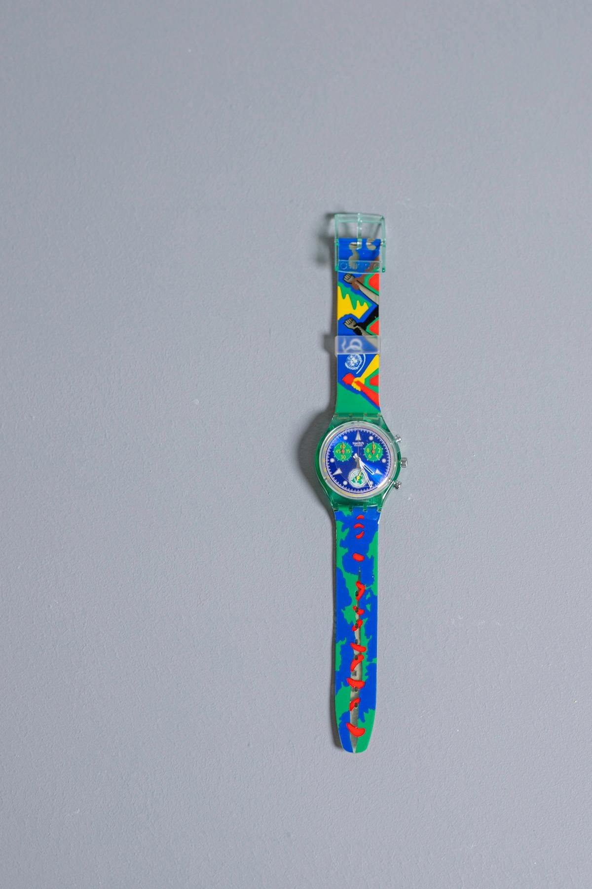 Vintage Swatch from the 1995 collection is dedicated to the 50th anniversary of the United Nations. To celebrate this special anniversary, this Swatch was designed by a group of young artists from around the world. Kept in its original box, this