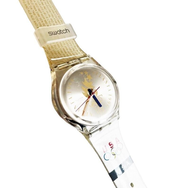 Discover a true gem from the 1990s with this vintage Swatch Swiss Atlanta 1996 Olympic Games GZ150J analog watch. It's a brand new, unused timepiece that has been stored in its original case, and we've even installed a fresh battery to ensure it's