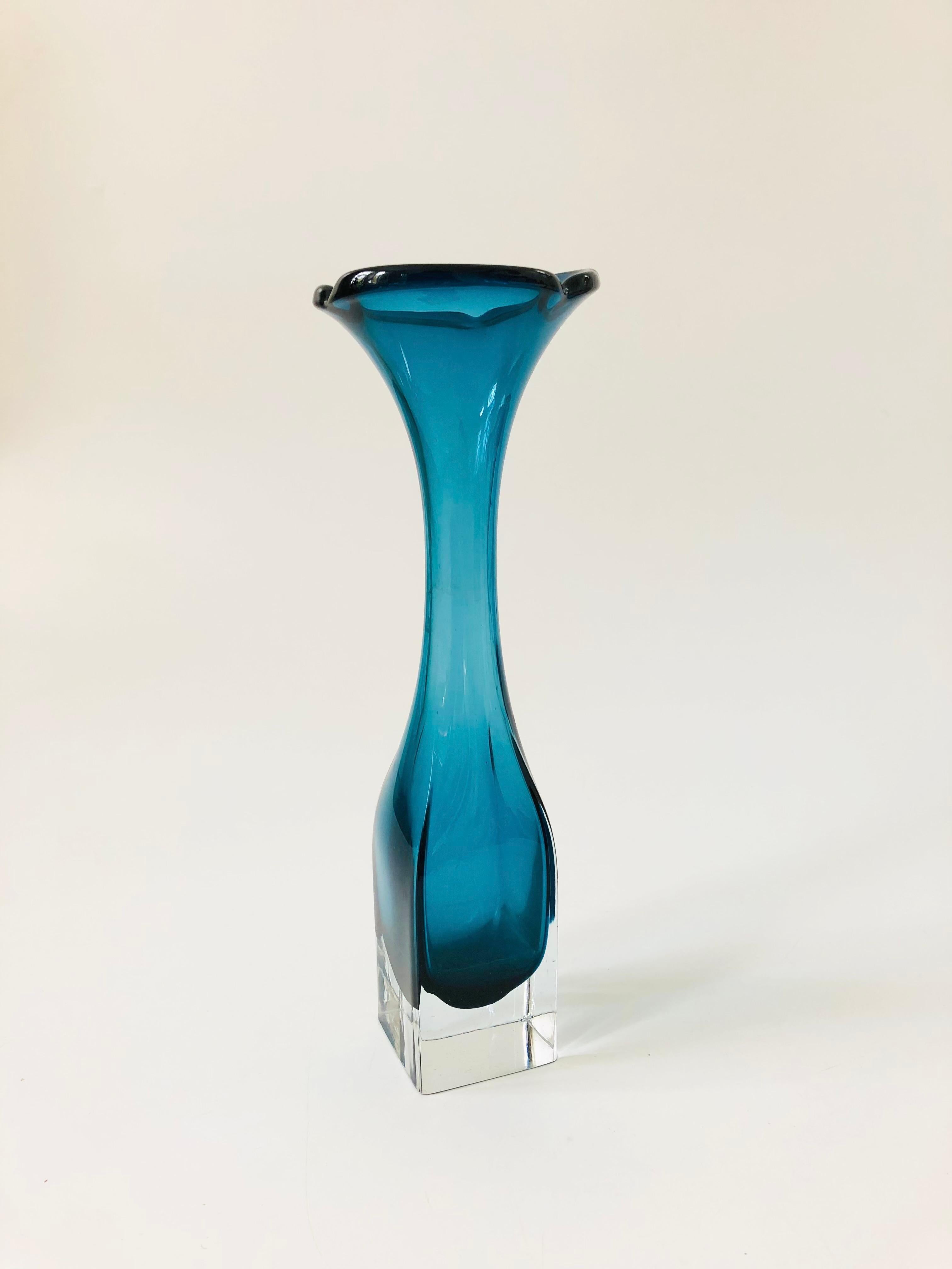 A beautiful mid century Swedish art glass vase, designed by Bo Borgstrom for Aseda Glasbruk in the 1960s. Beautiful deep blue color to the interior which is encased in thick clear glass. An organic shaped top contrasts nicely with a blocky square