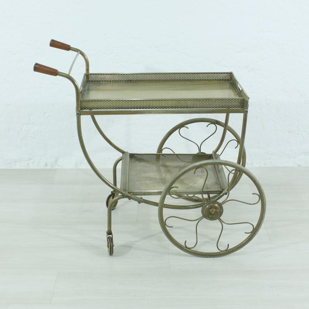 This brass, wood, and hard rubber trolley features removable trays.