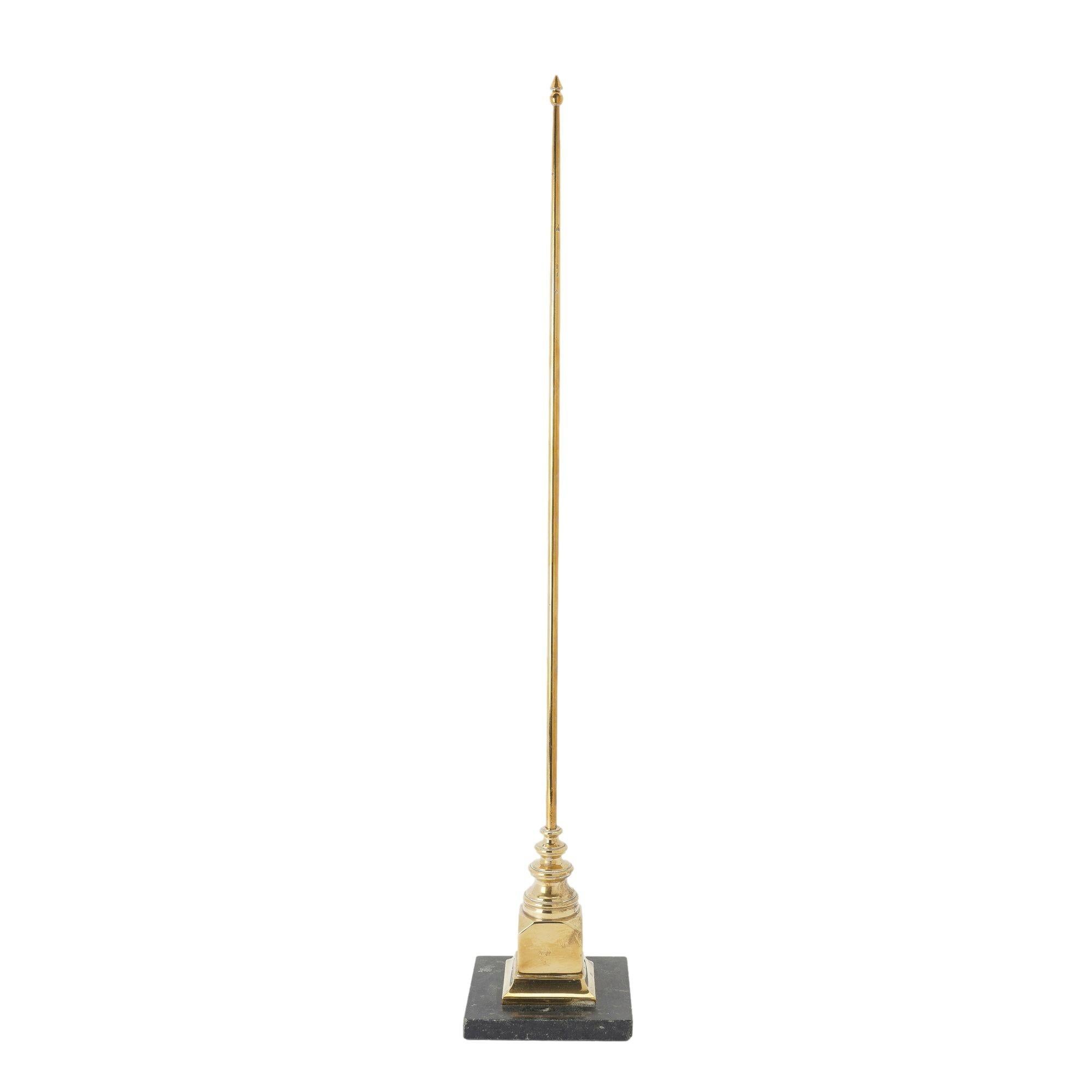Cast brass yachting trophy in the form of a mast. The bottom of the column featured graduated ring turnings which rest on a square brass base and plinth and are mounted on a base of square black marble.

Sweden, circa 1950.