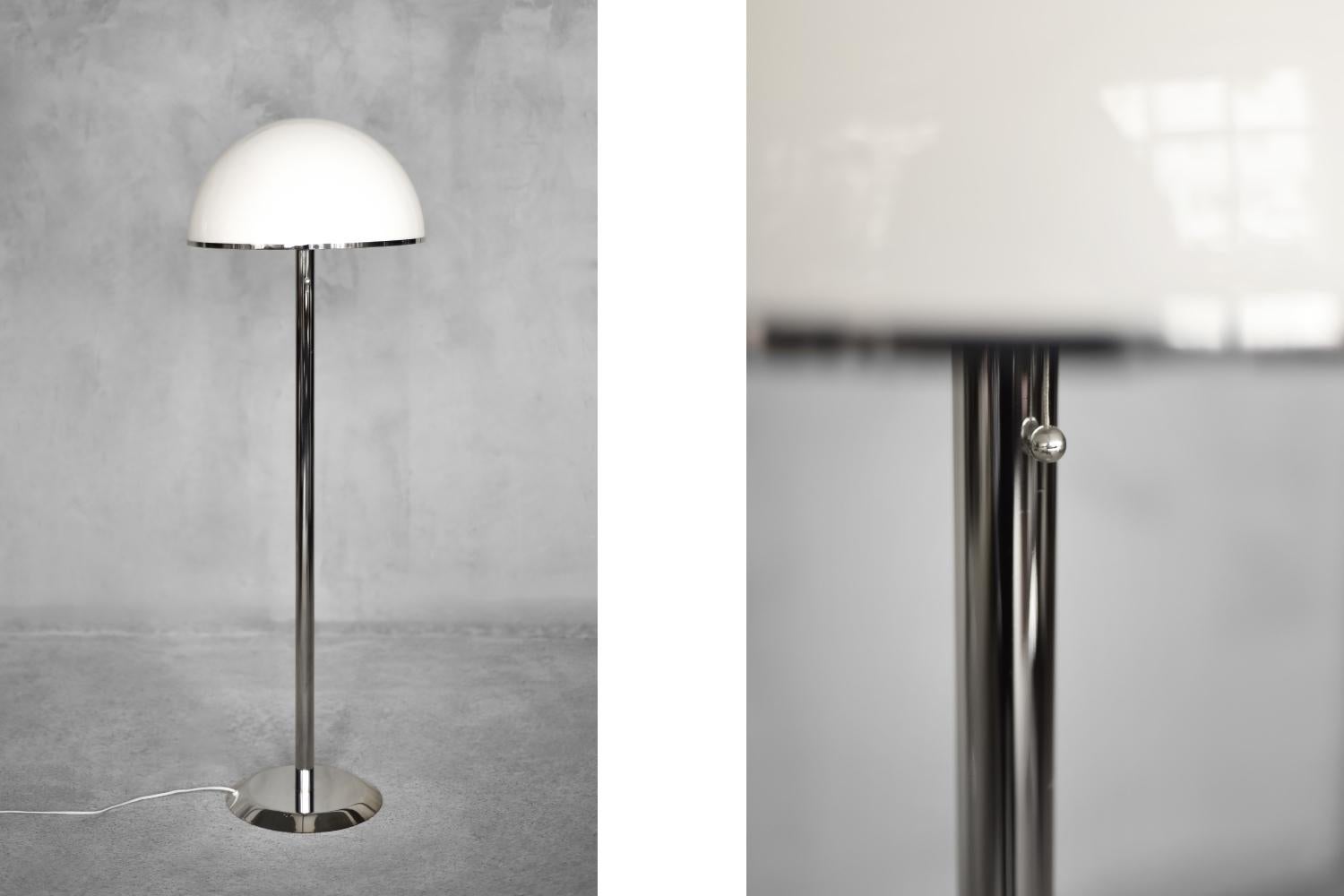 This rare floor lamp NAFA type 504 was manufactured by the Swedish manufacturer Nybro Armaturfabrik during the 1970s. It is made of chrome-plated steel, and the large, domed shade is made of white acrylic with a silver metal rim. Acrylic is a