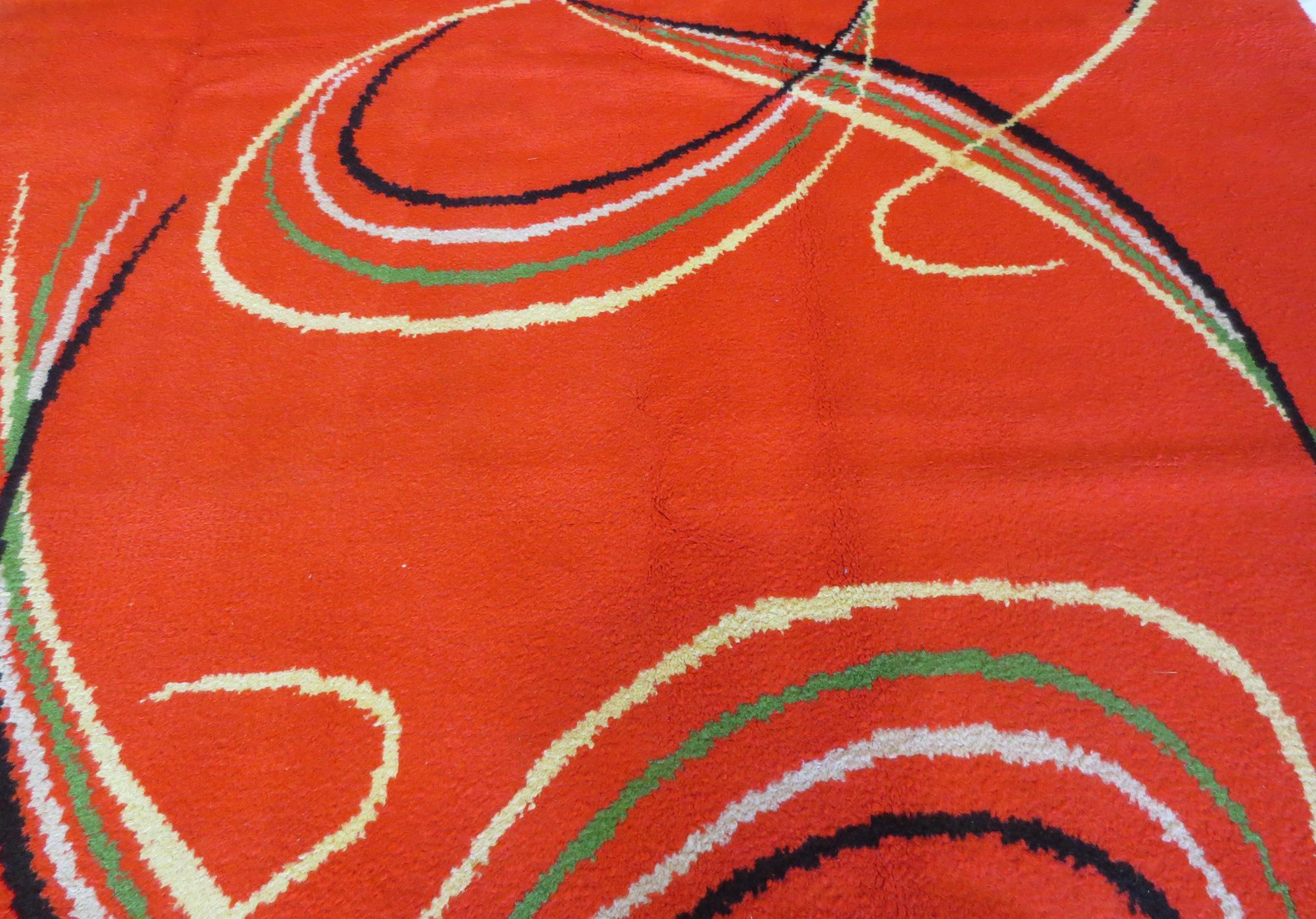 This a boldly colored vintage Swedish deco shag rug from the mid-20th century with expressive lines that give it distinct character. It's an exciting piece, with organic, curvy lines that creates movement on a backdrop of a vivid bright red color. A