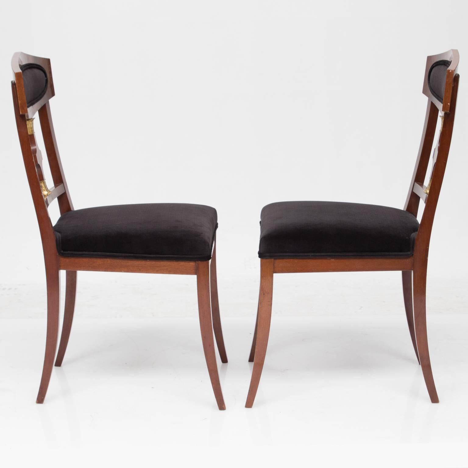A fine pair of Swedish Empire style occasional chairs, very decorative space fillers. Beautifully flamed mahogany backs centered with an oval chocolate brown Ralph Lauren velvet. A distinctive splat with two metal capital caps. A matching fabric