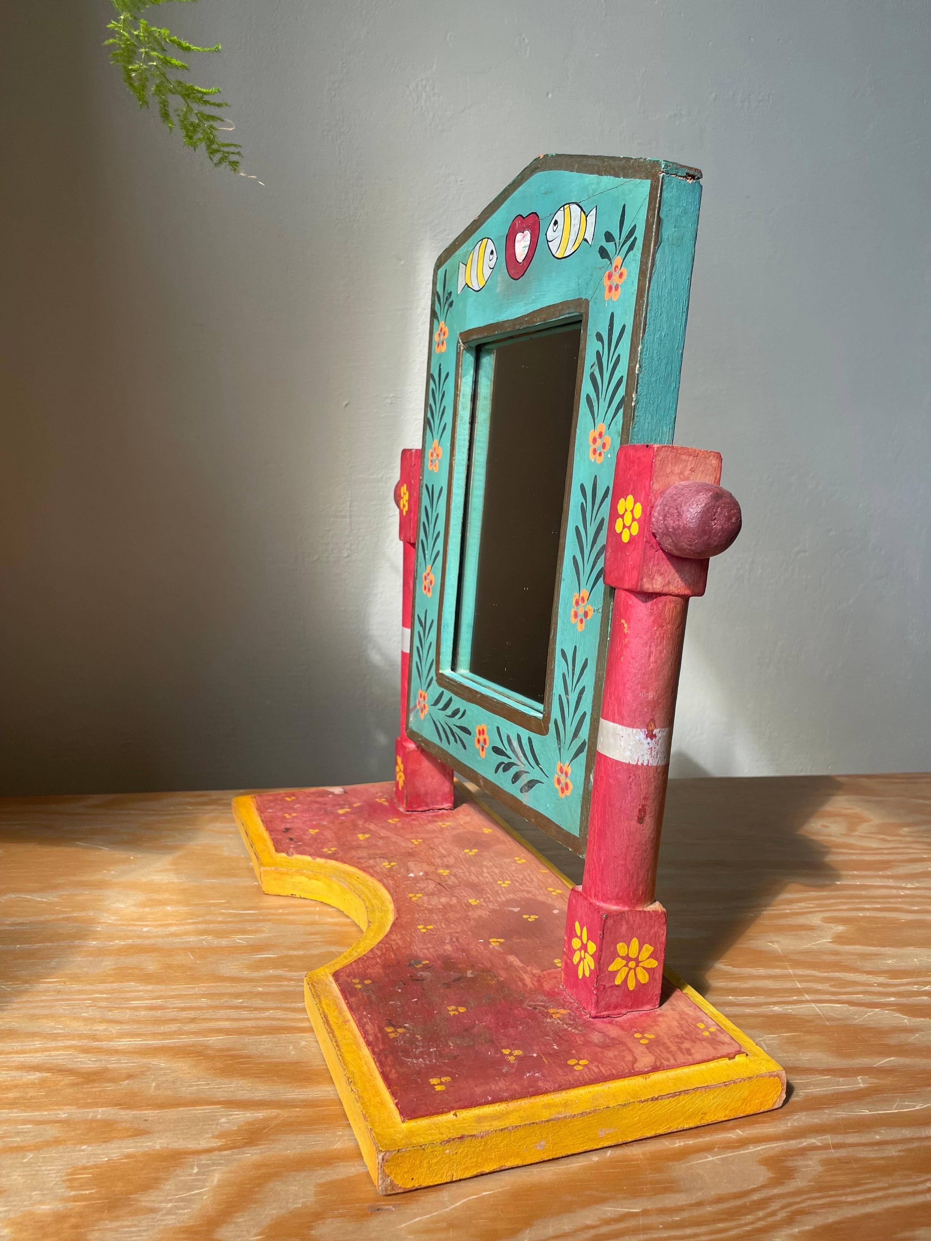 Handmade multicolored wooden Swedish allmoga folk art boho style table mirror. Handpainted floral, organic and simple decorations in red, coral, orange, yellow, light blue, green, gold and white. Great vintage condition. 
Sweden, circa 1970s.