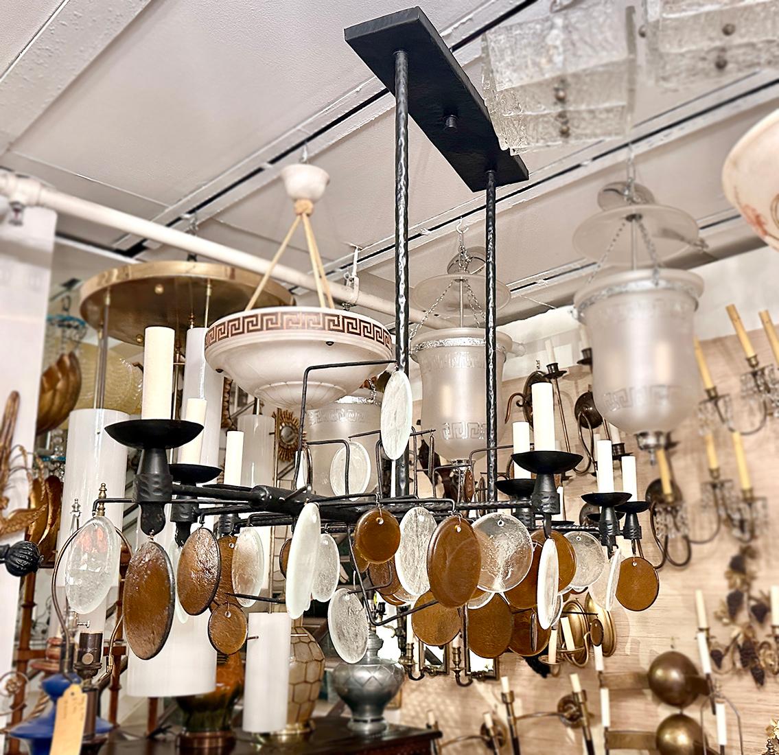 A Swedish Horizontal Hammered Iron light fixture with glass pendants with 12 lights.

Measurements:
Drop: 39