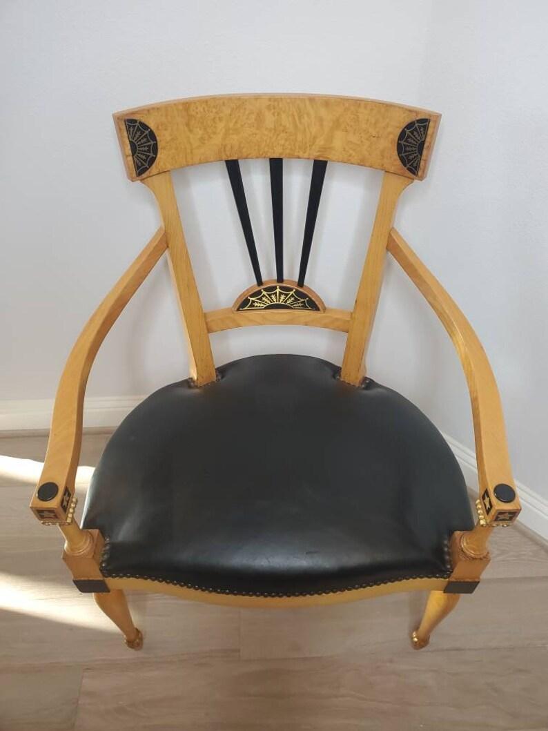 A vintage Swedish Karl Johan / Biedermeier style birchwood oversized dining / armchair.

Featuring a figured satin birch concave top rail with inlaid panel adorned flanks, into ebonized wooden splat of three vertical tapering spindles, above an