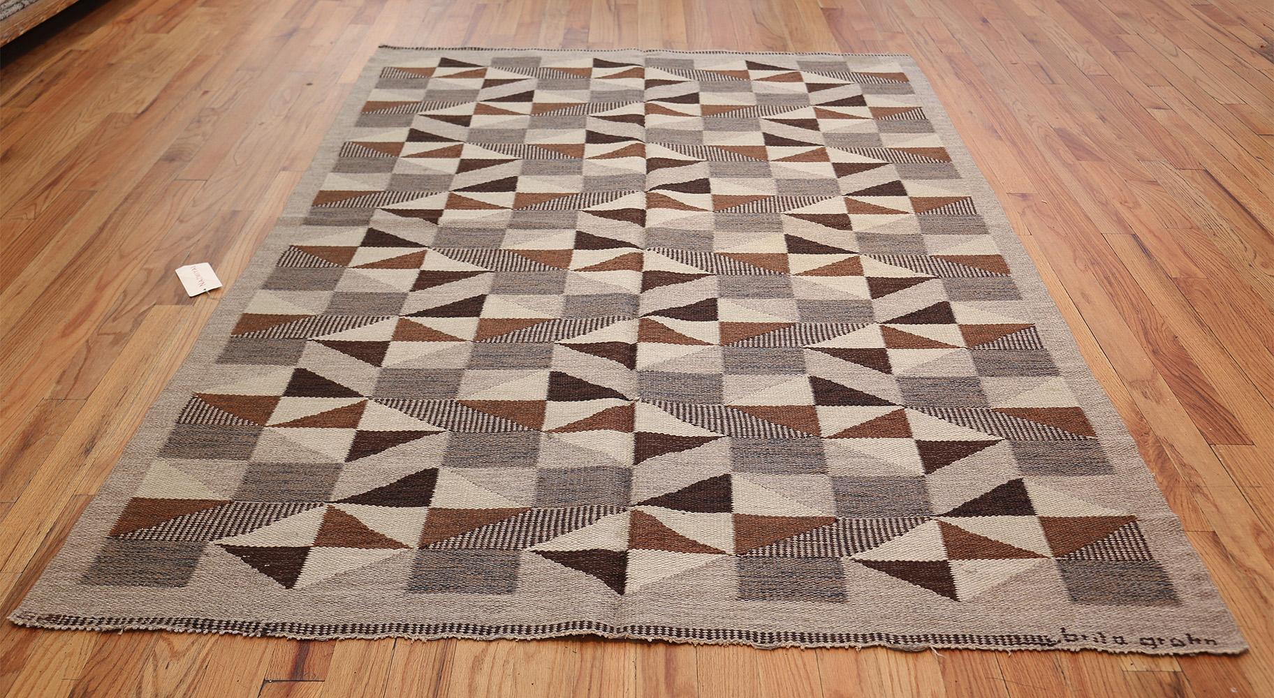 Swedish rug, Scandinavia, mid-20th century. This Minimalist carpet transforms simple half-square, diamond and quarter-square motifs into a graceful geometric pattern with meandering rows of zigzags and layers of secondary figures formed by the